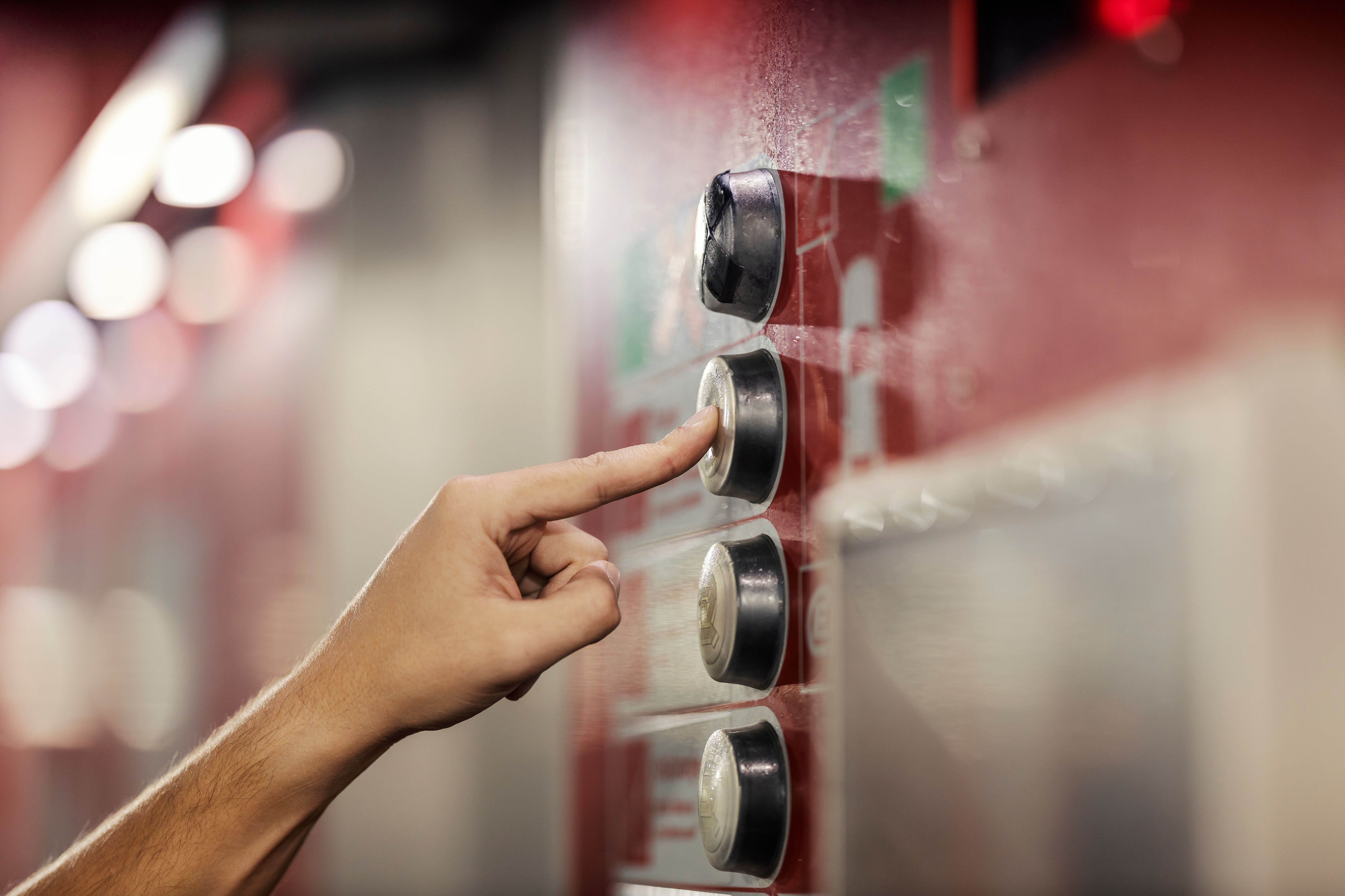Close up of a hand pressing a button on a coin machine at car wash station. Close up of a hand pressing a button on a coin machine at car wash station.