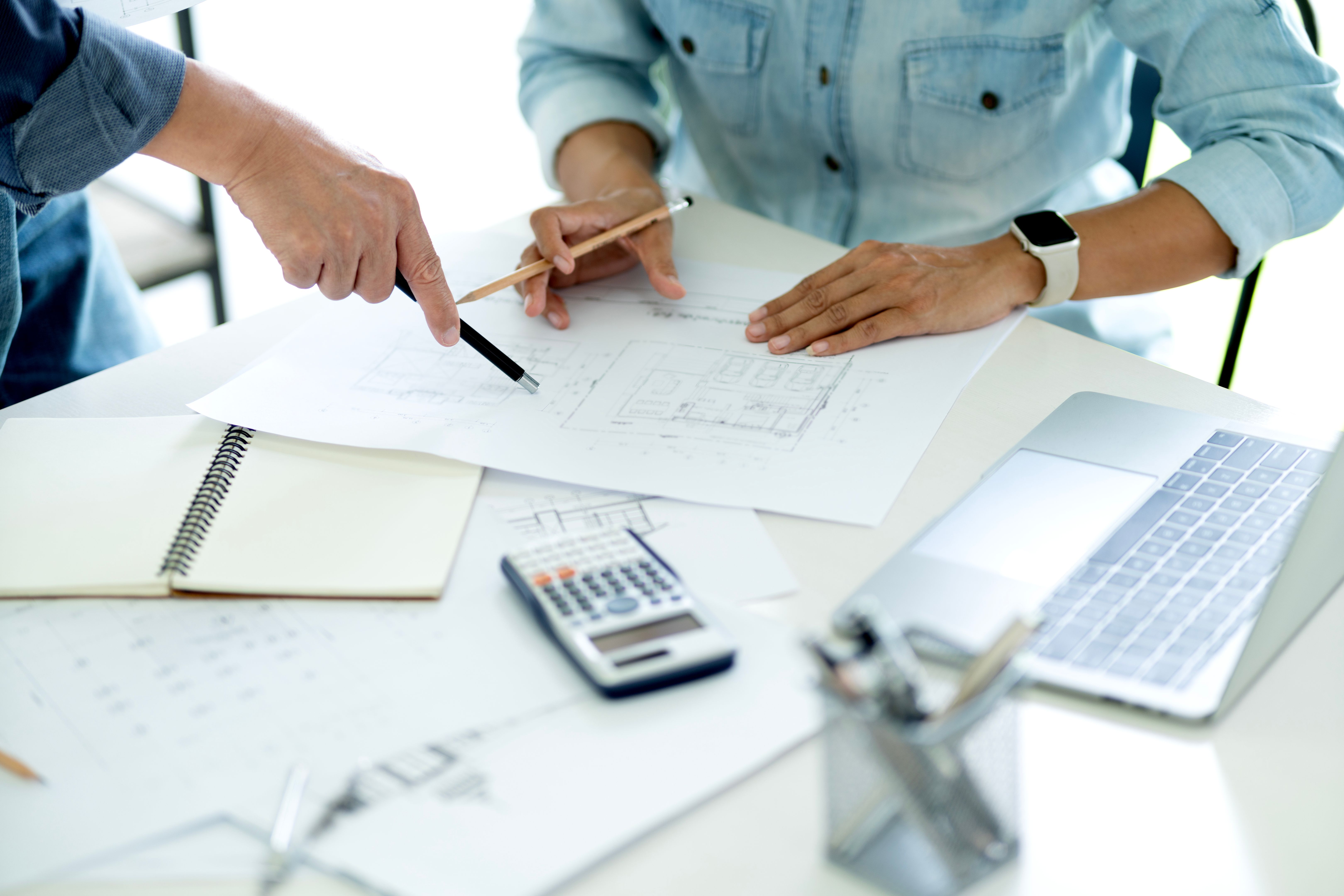 A team of architects or engineers is consulting with each other