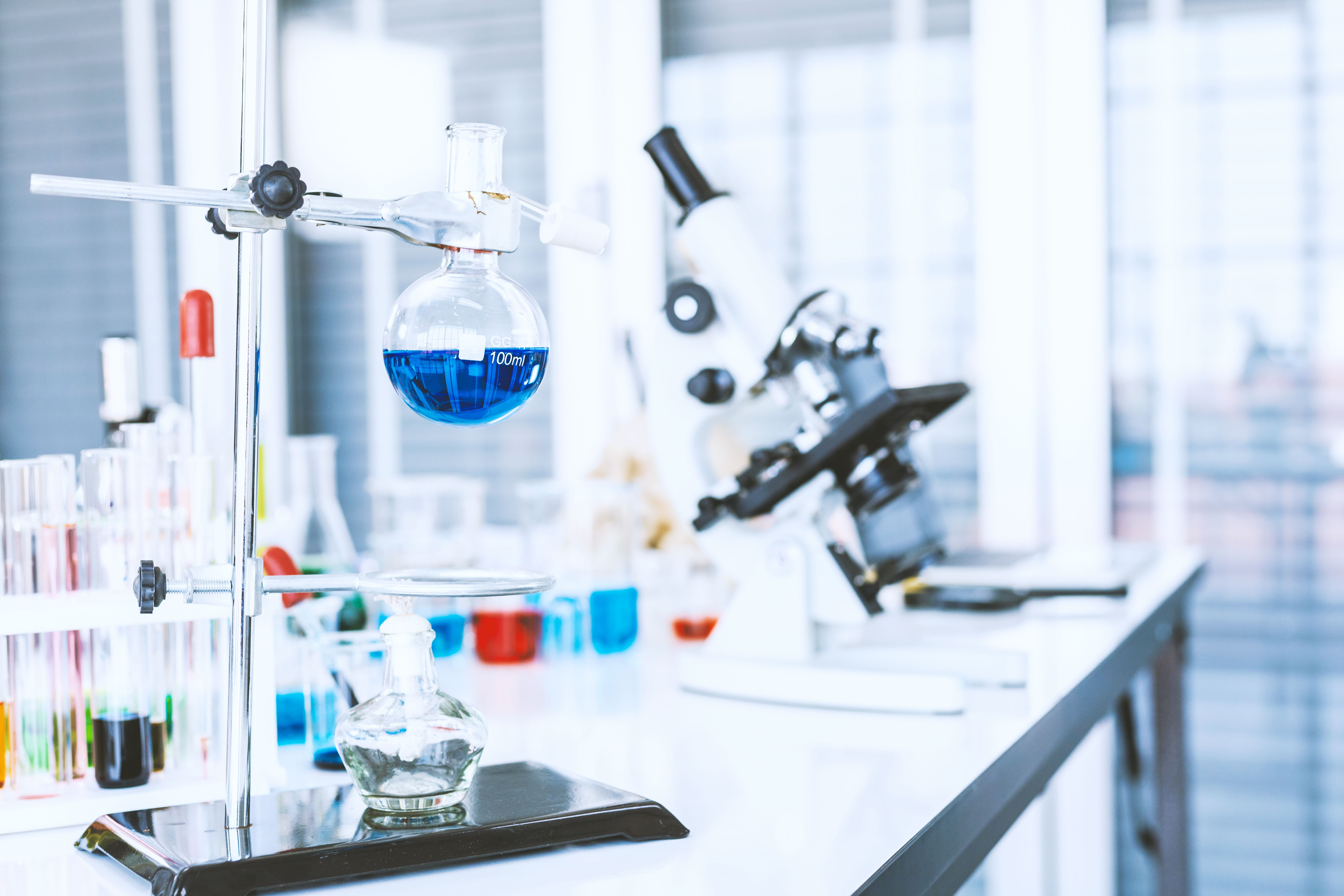 test tubes with lab glassware on the table in laboratory background, research and Scientific concept