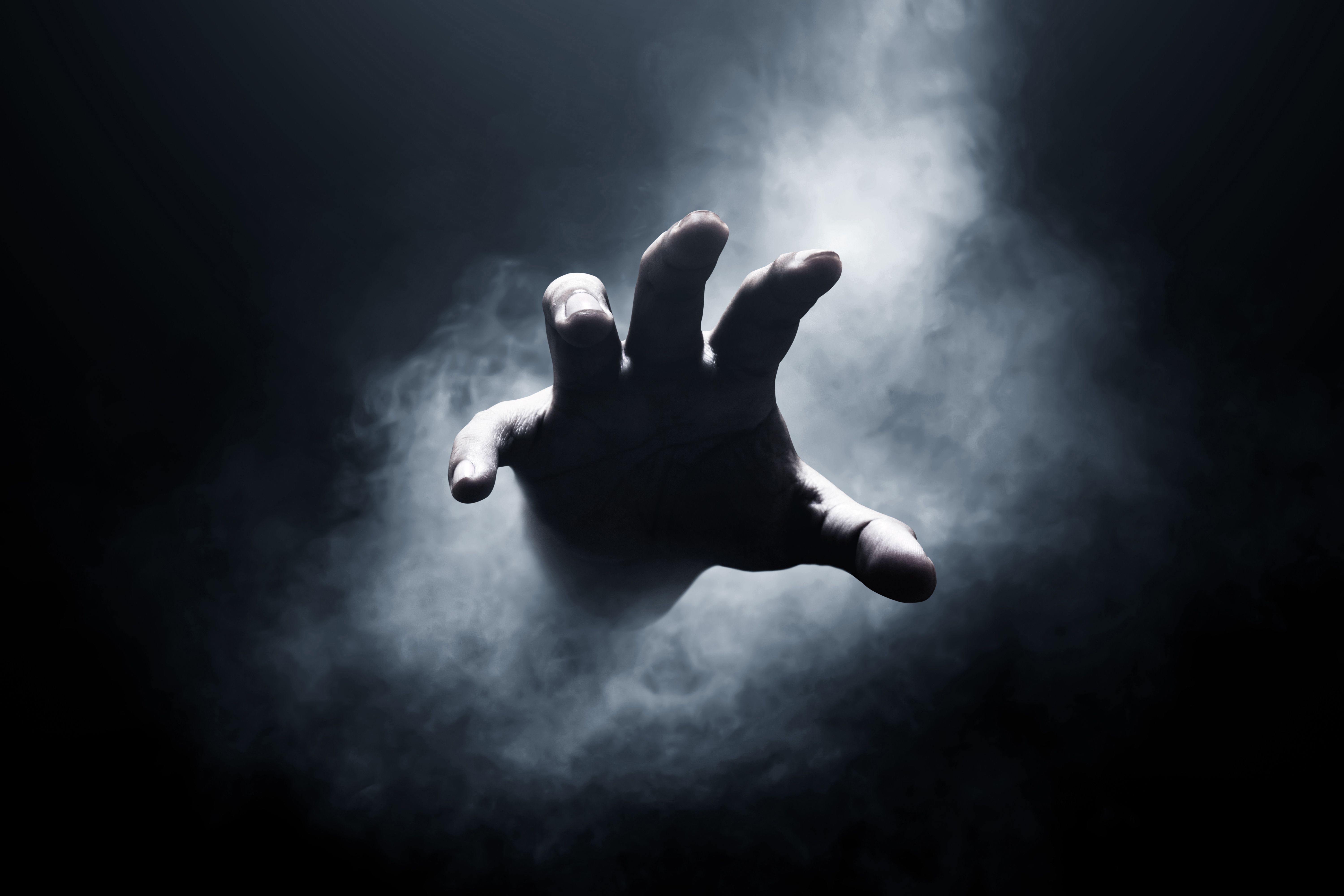 Human hand on dark background