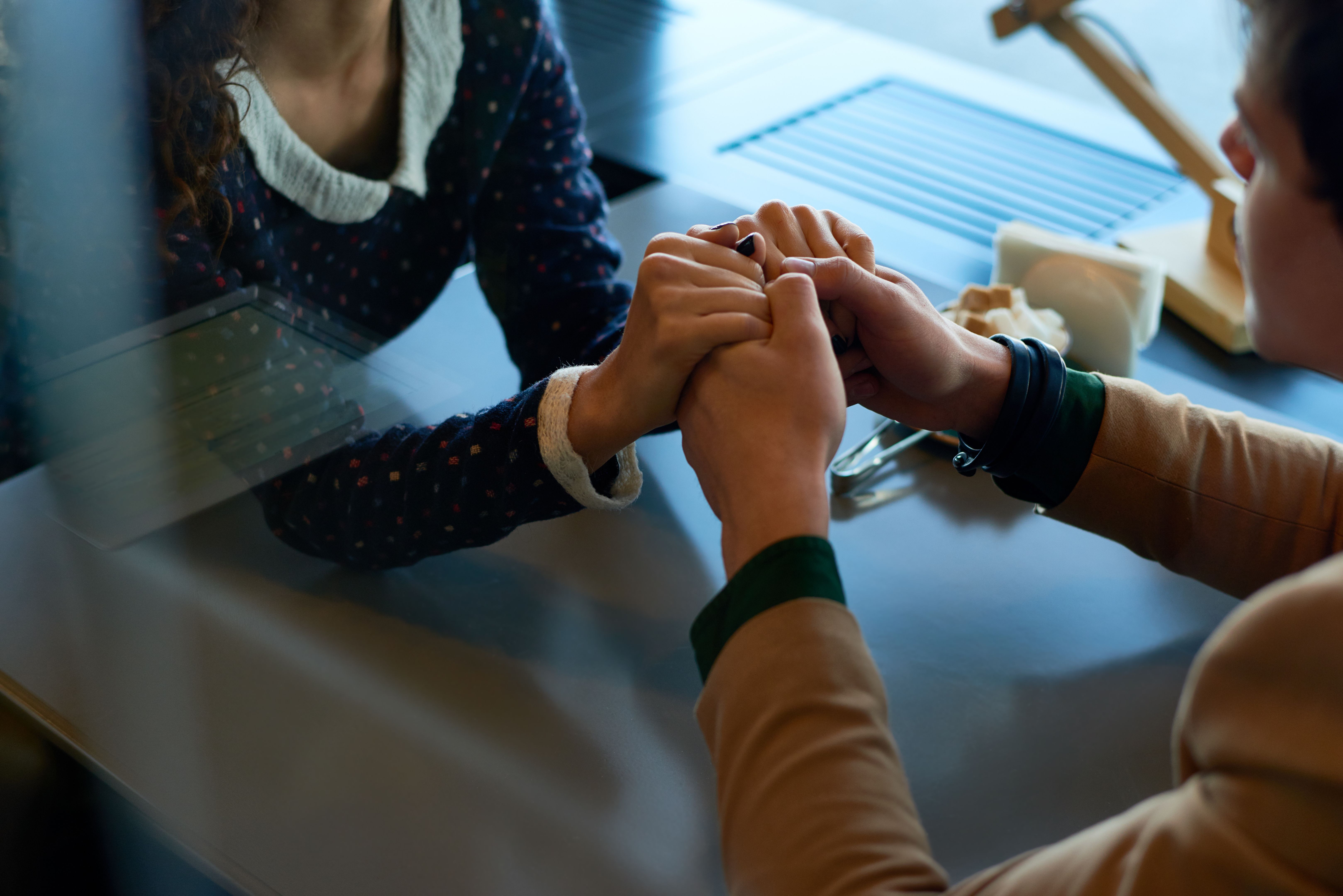 people holding hands in church