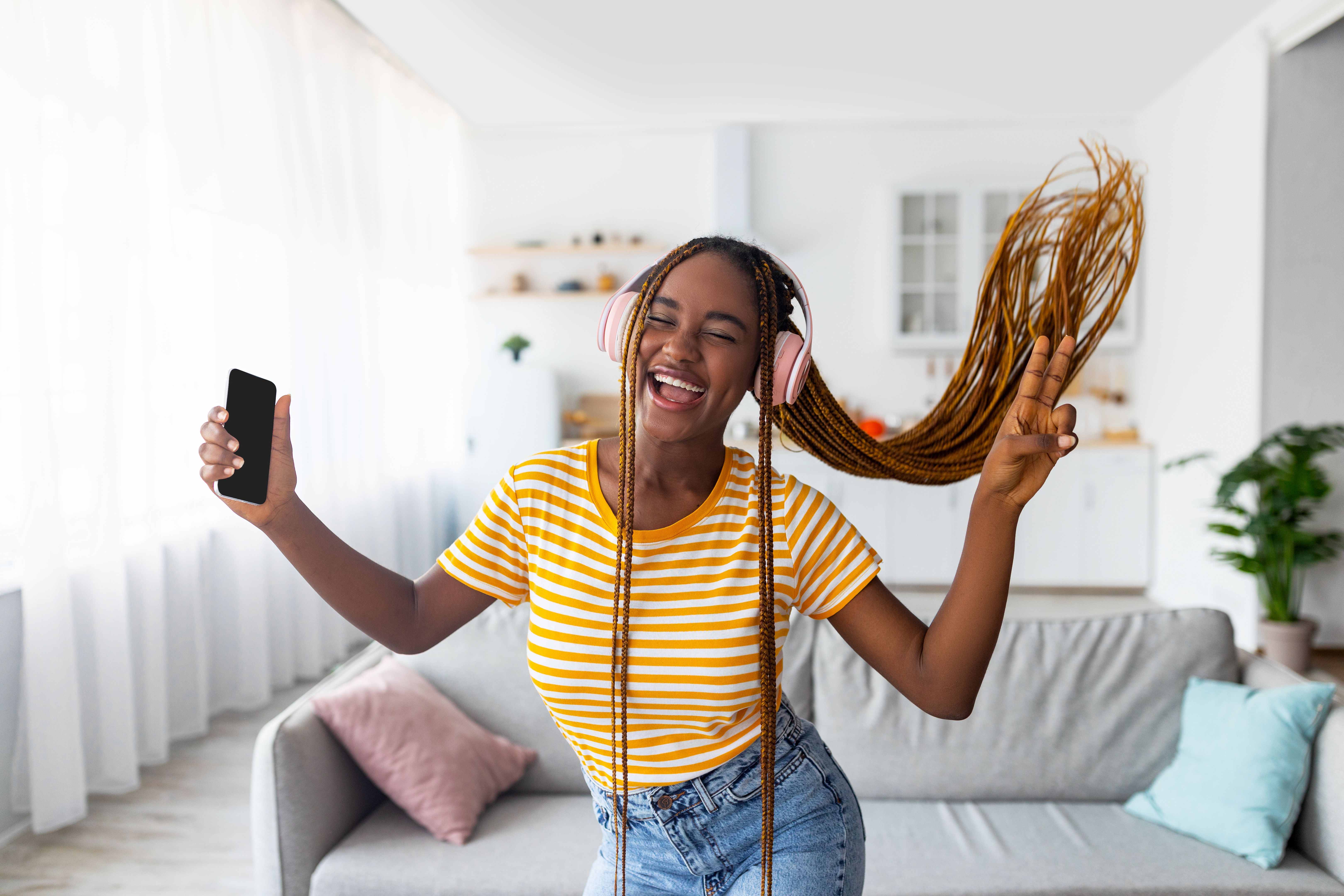 Emotional black lady music lover enjoying nice stereo headset Emotional black lady music lover enjoying nice stereo headset