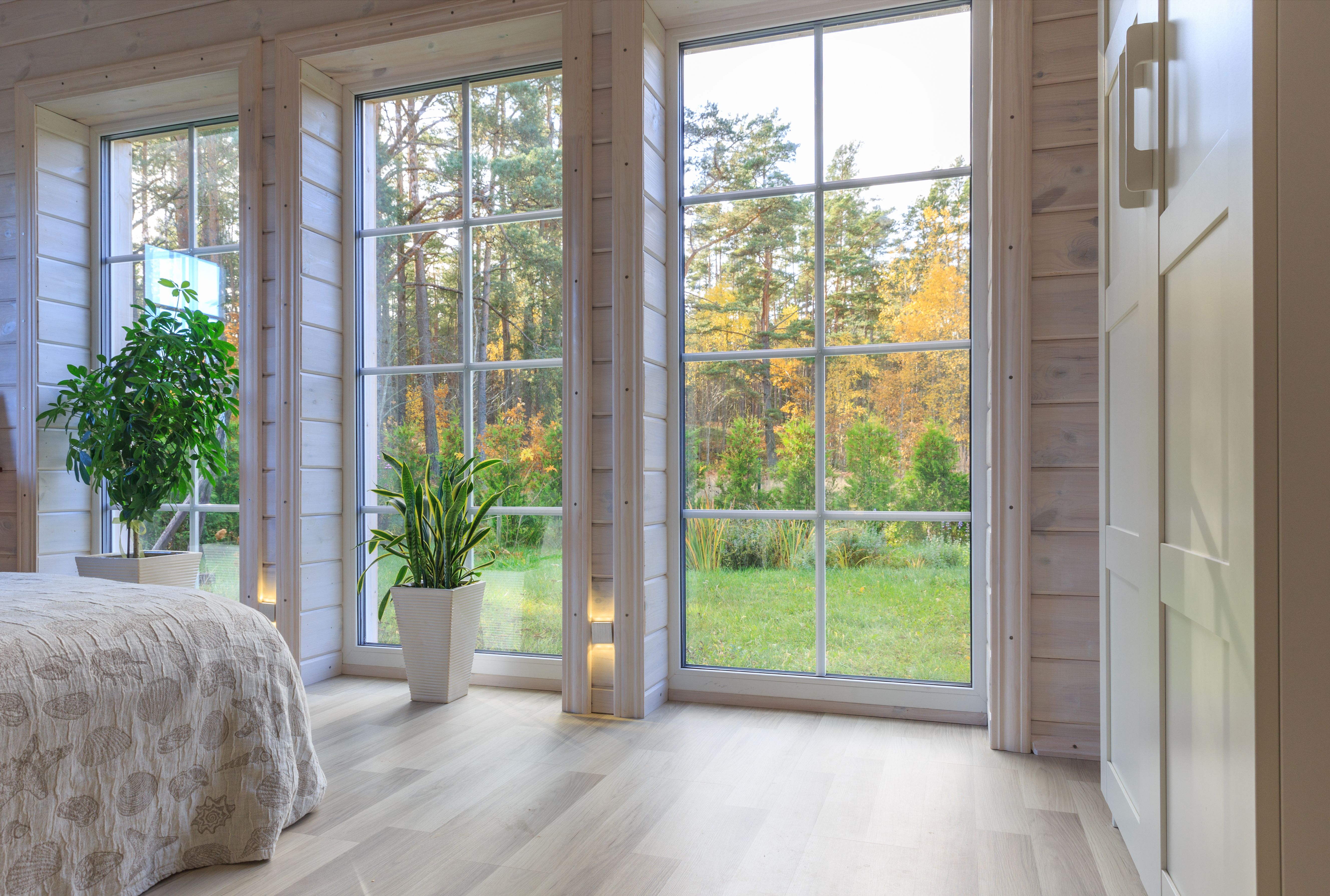 Bright photo studio interior with big window, high ceiling, white wooden floor