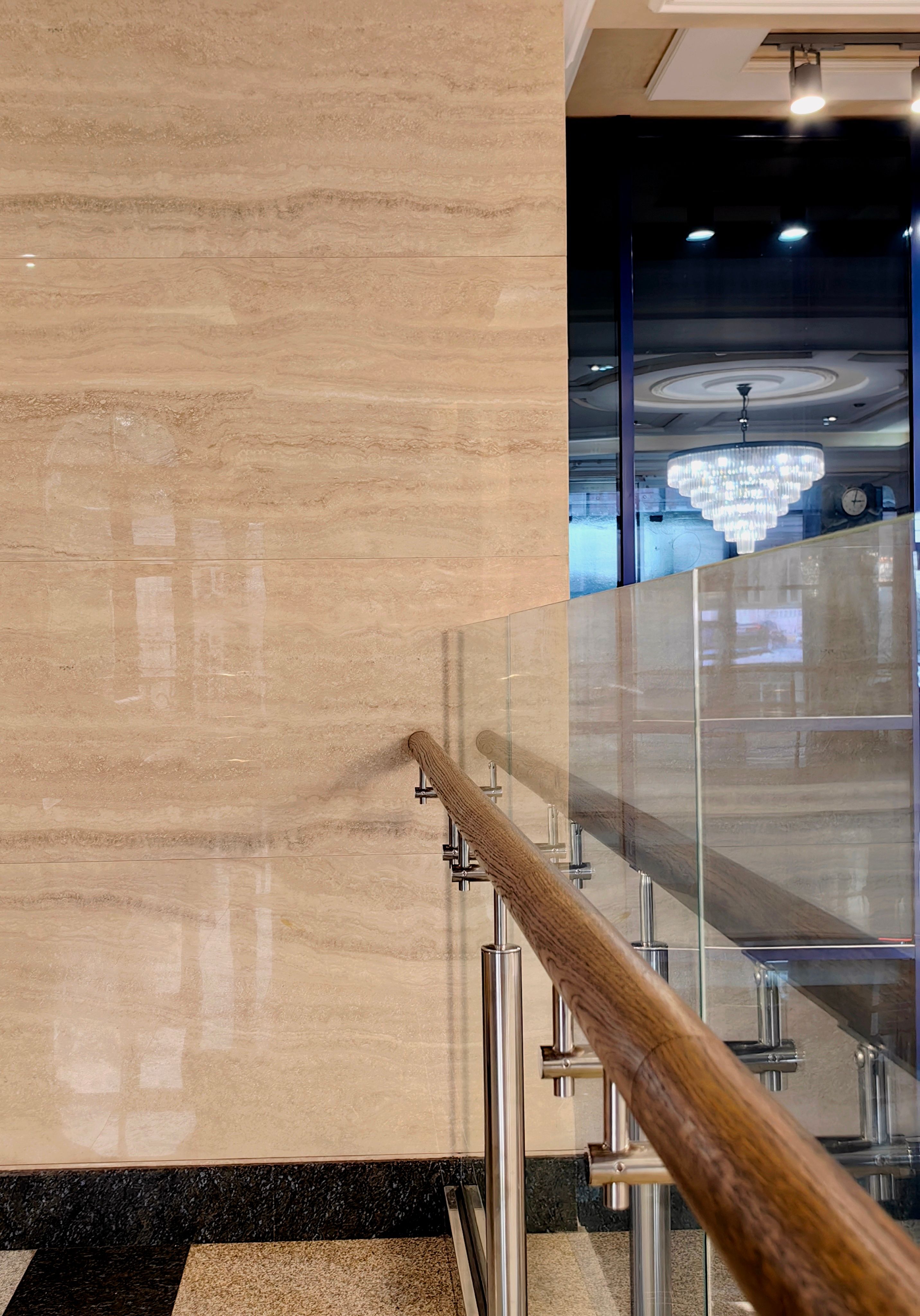 elegant interior design from glass railings and polished marble walls in modern building. closeup. elegant interior design from glass railings and polished marble walls in modern building. closeup.