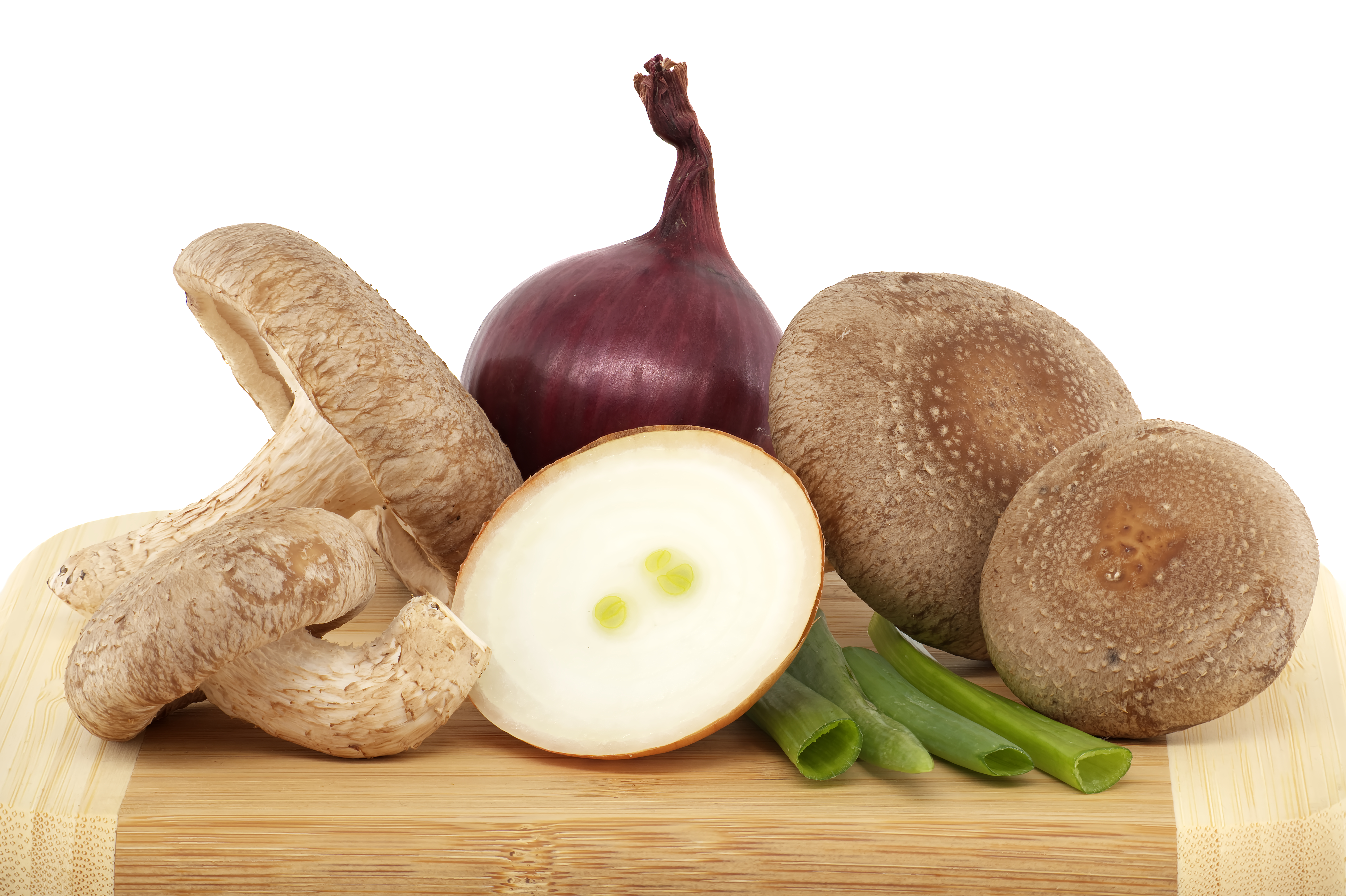 Fresh shiitake mushrooms and onions over white background