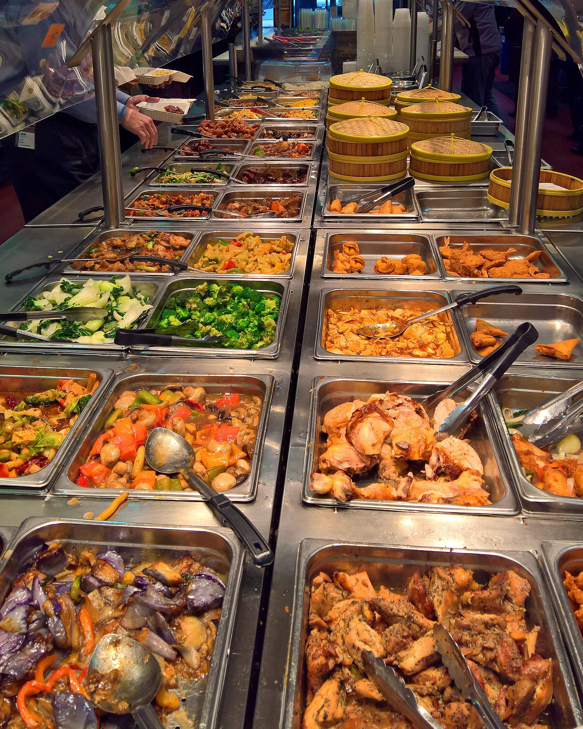 Vertical shot of a buffet with Chinese food and dim sum items