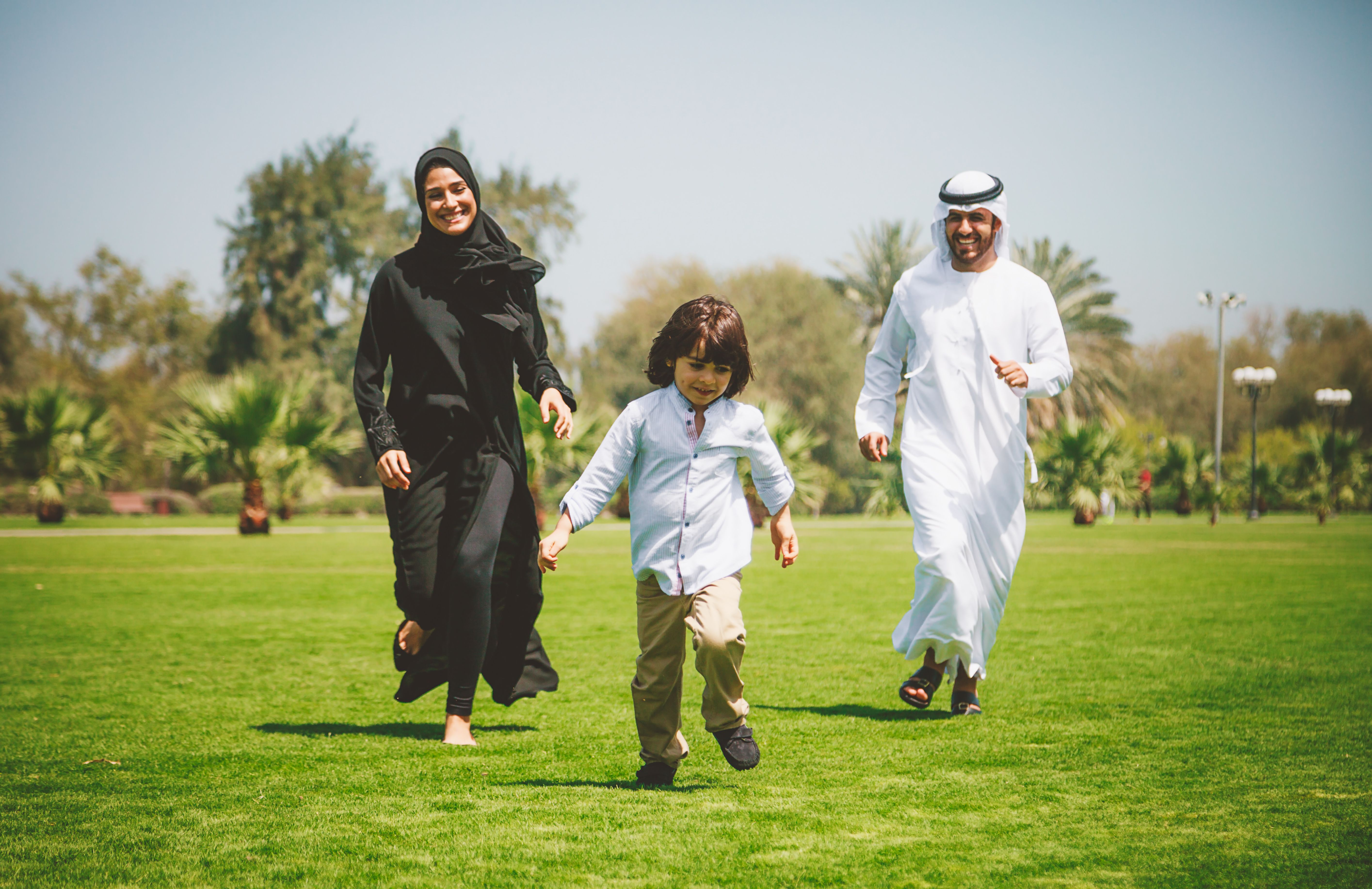 Happy Young Arabic family having fun outdoors at sunny day
