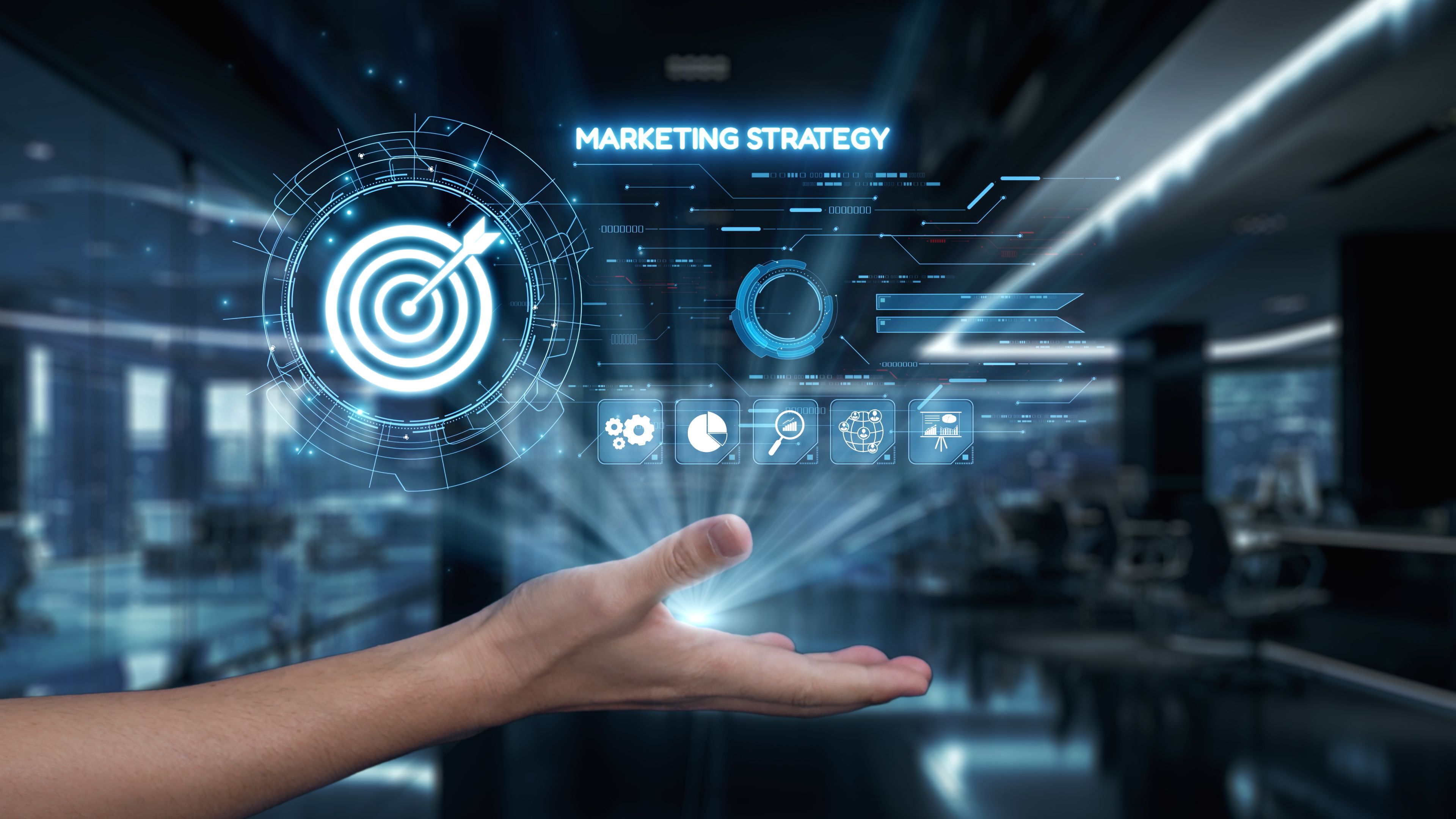 Futuristic Marketing Strategy Concept with Hand Supporting Target Icon and Data Analytics in Modern Office Environment. Auvana