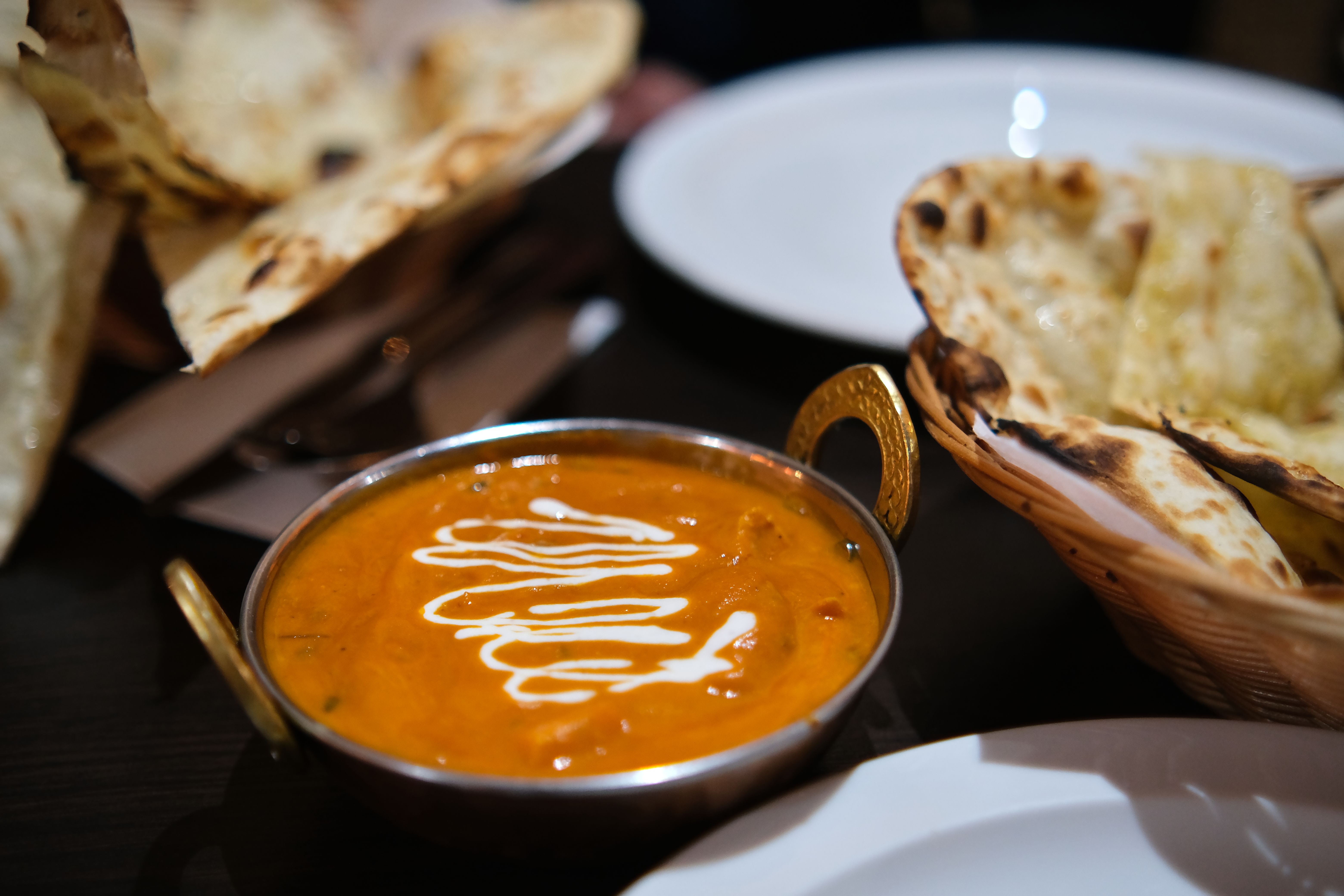 A bowl of creamy tikka masala chicken, rich in orange-red sauce. A bowl of creamy tikka masala chicken, rich in orange-red sauce.