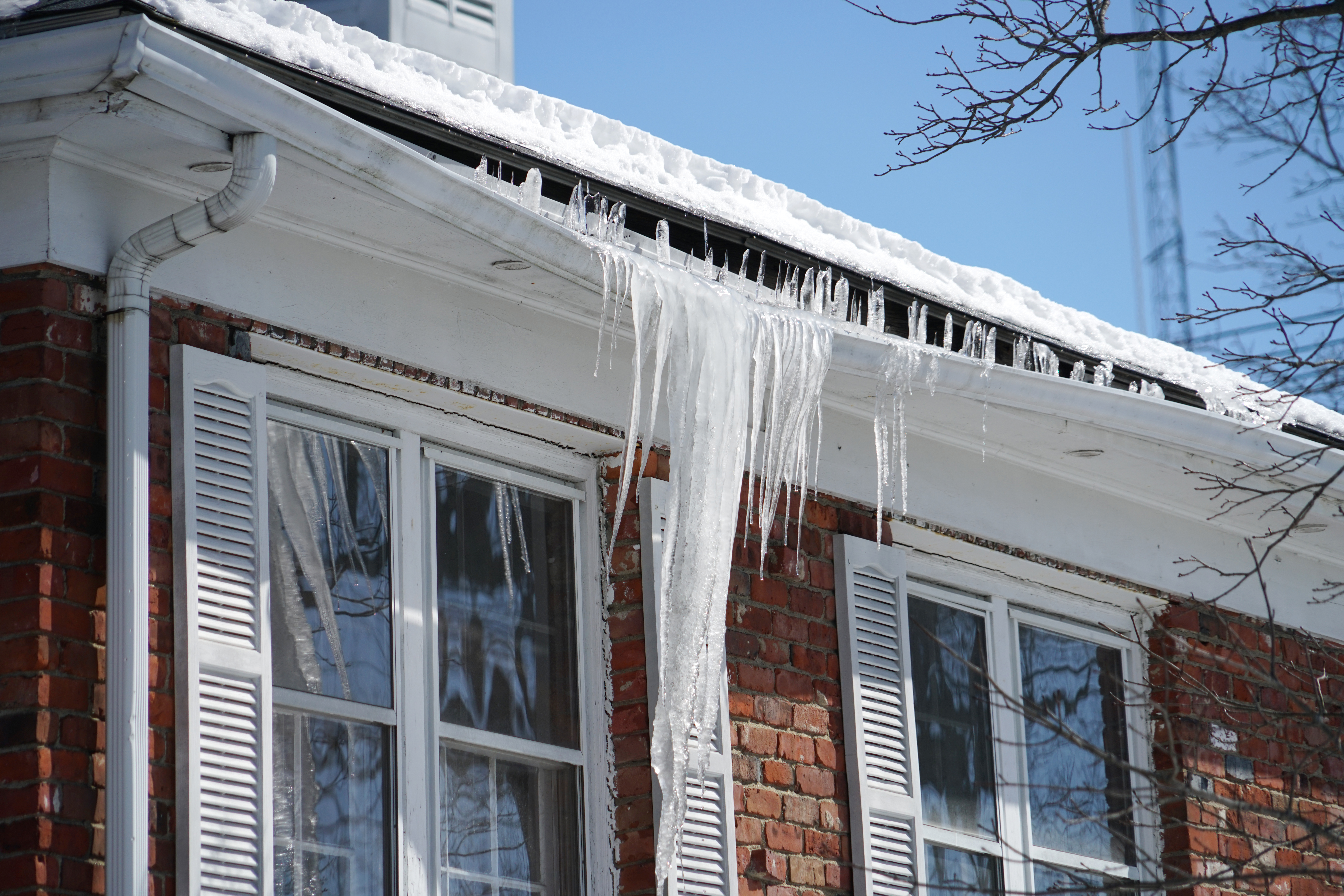 icicle on the house roof in winter season icicle on the house roof in winter season