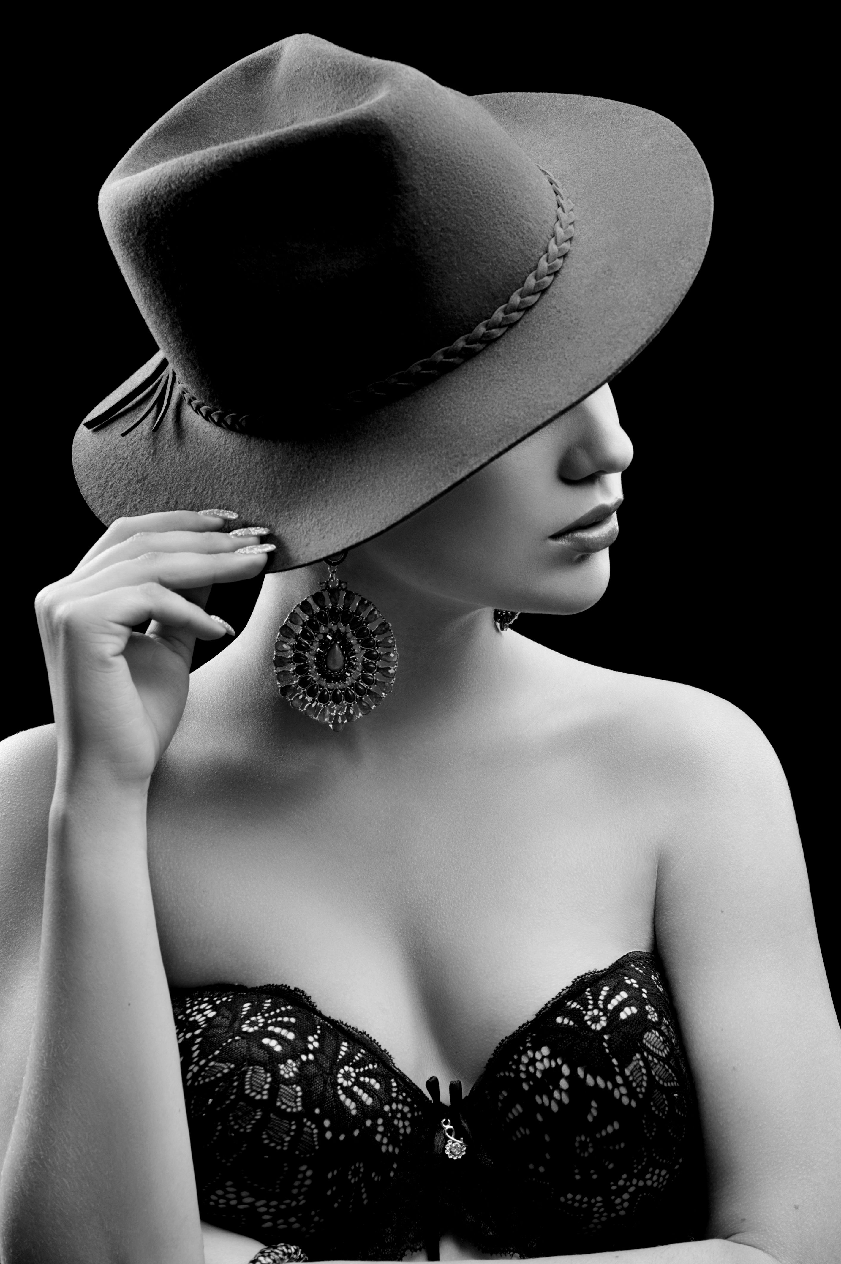Elegant female model wearing a hat hiding her face