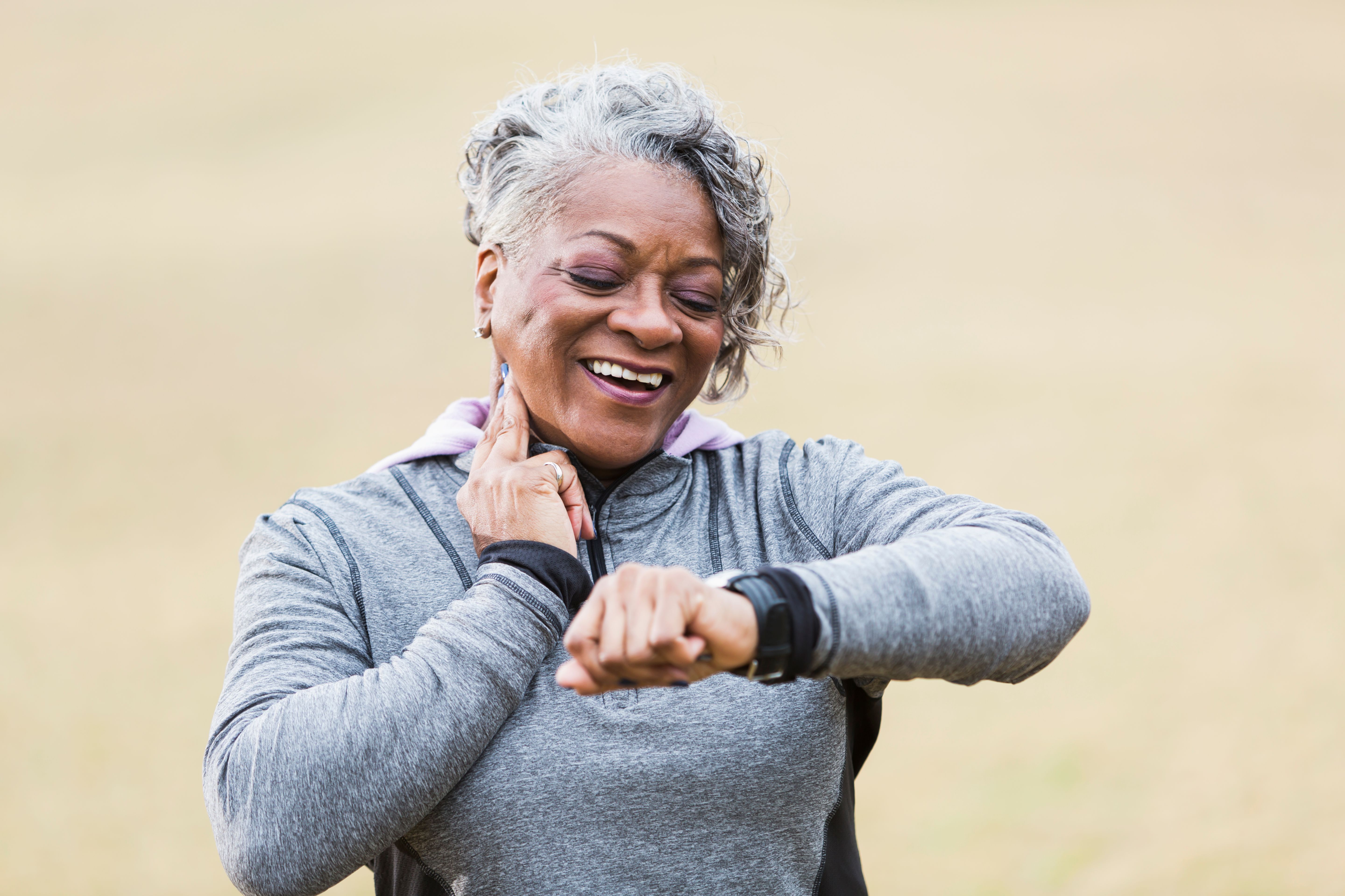 Senior woman exercising, taking pulse