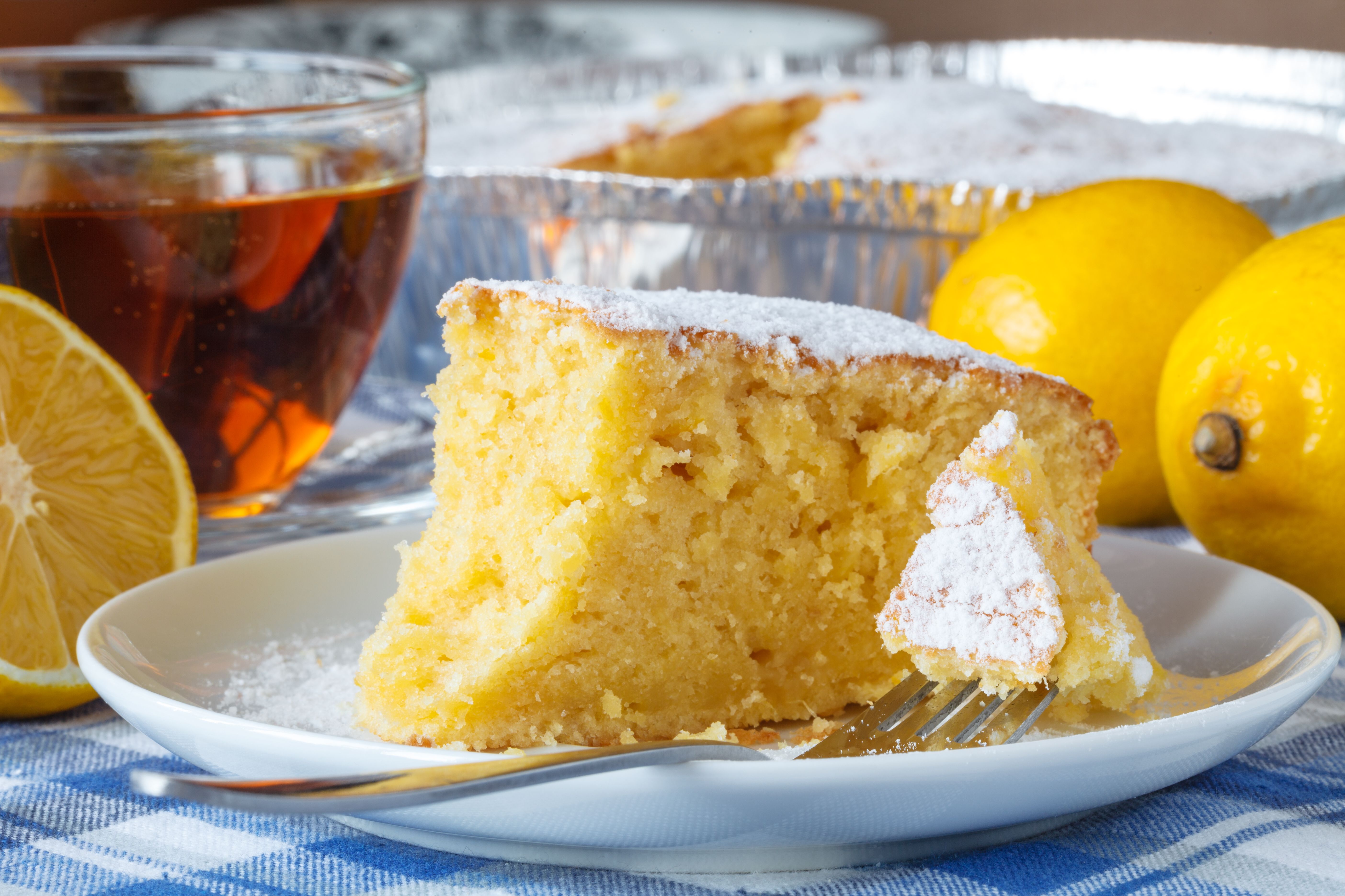 emon cake with sugar powder on the wooden table emon cake with sugar powder on the wooden table