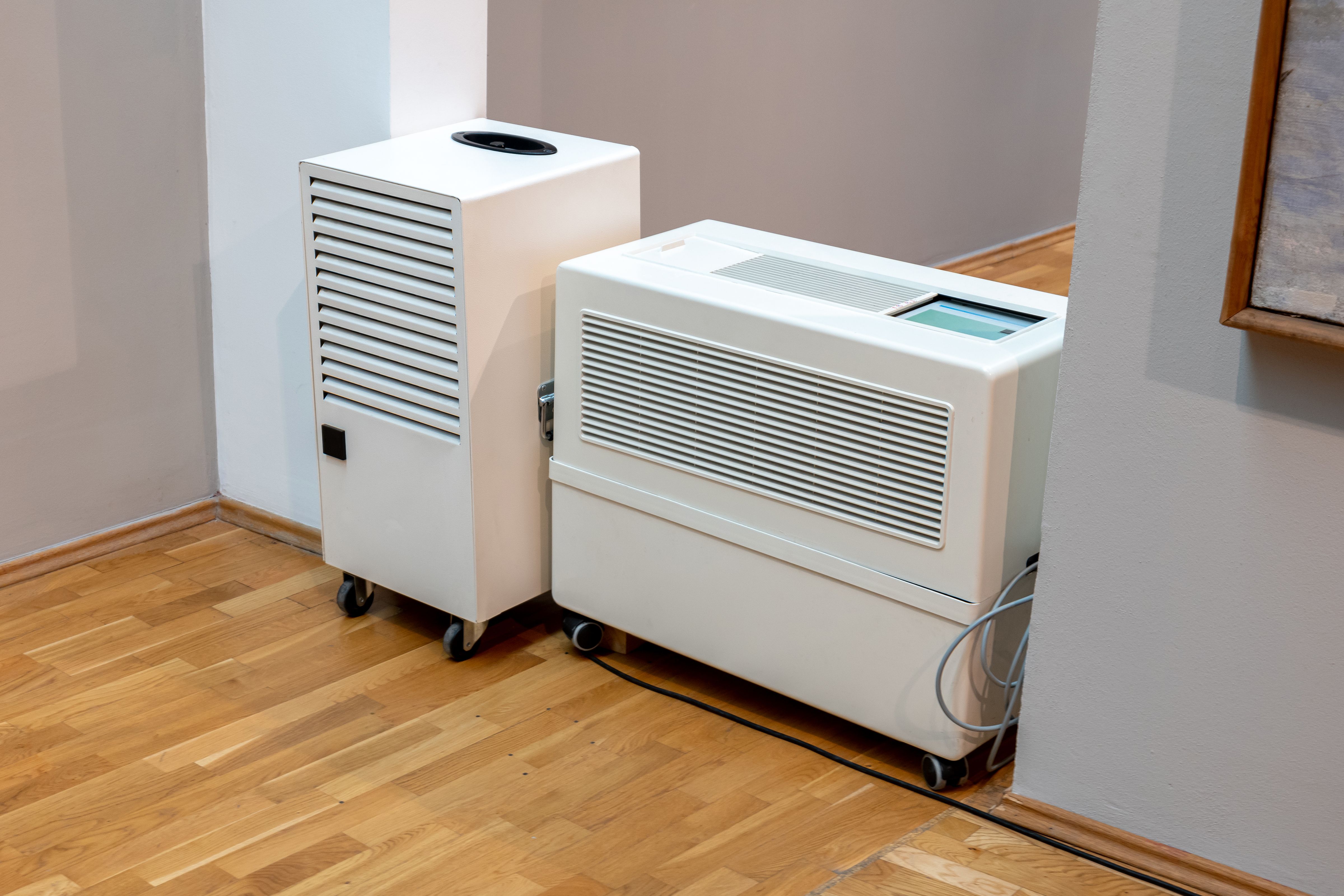 A modern industrial dehumidifier and an air purifier machine inside a museum, exhibition hall interior, keeping right air conditions, humidity levels control technology, old art protection concept