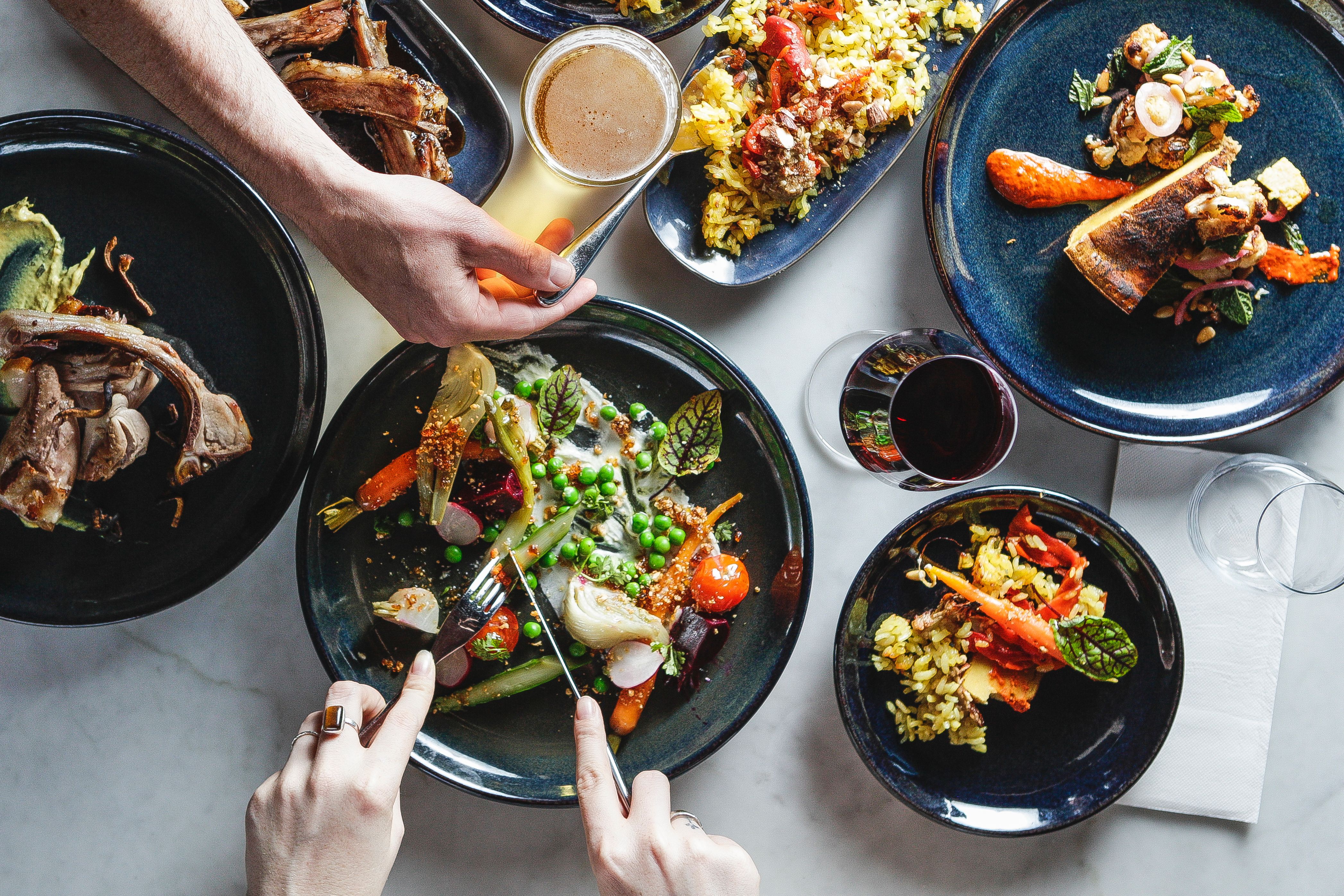 Two People Sharing Banquet Spread of Healthy Food Two People Sharing Banquet Spread of Healthy Food