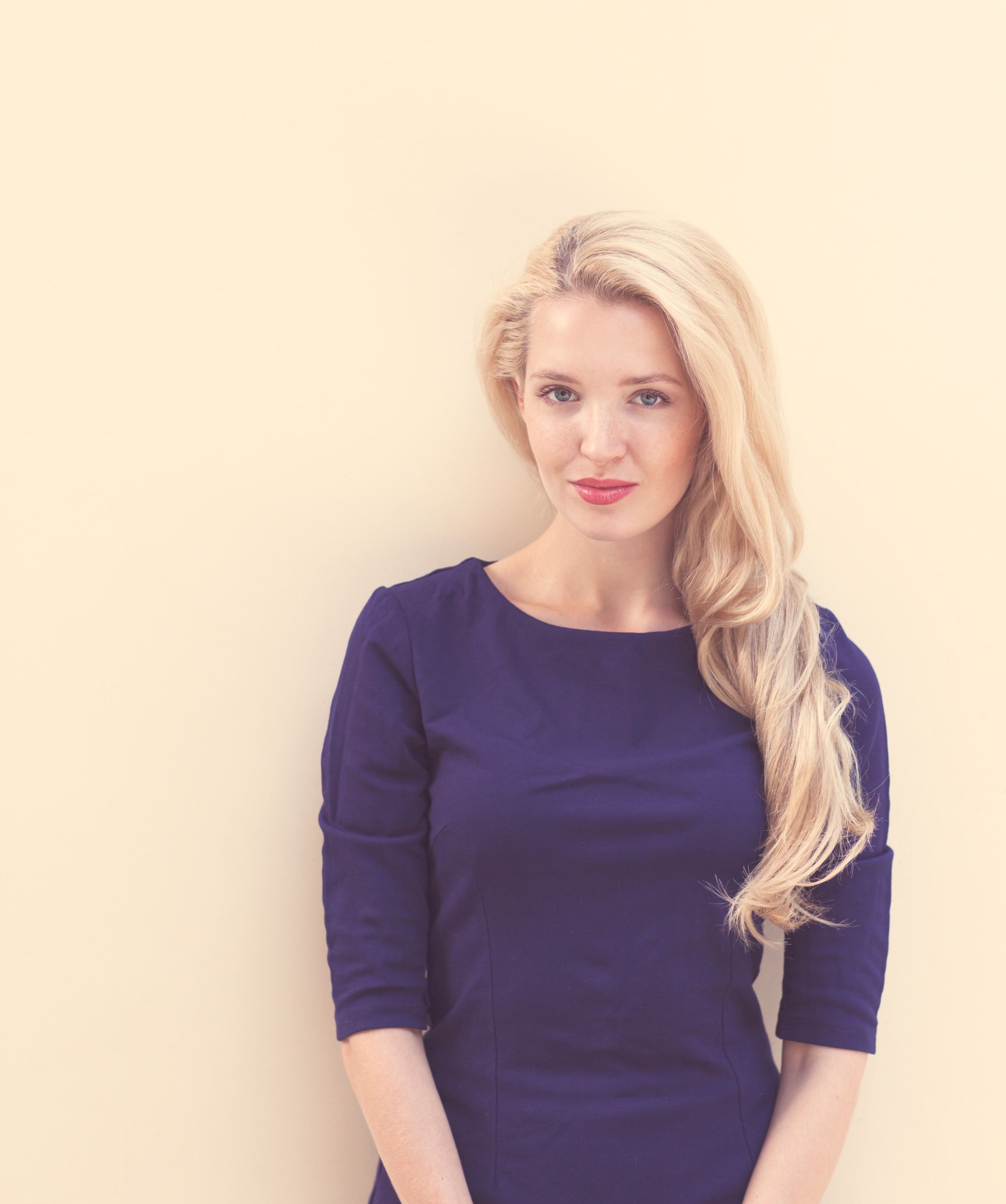 Summer portrait of young beautiful blond woman in blue dress