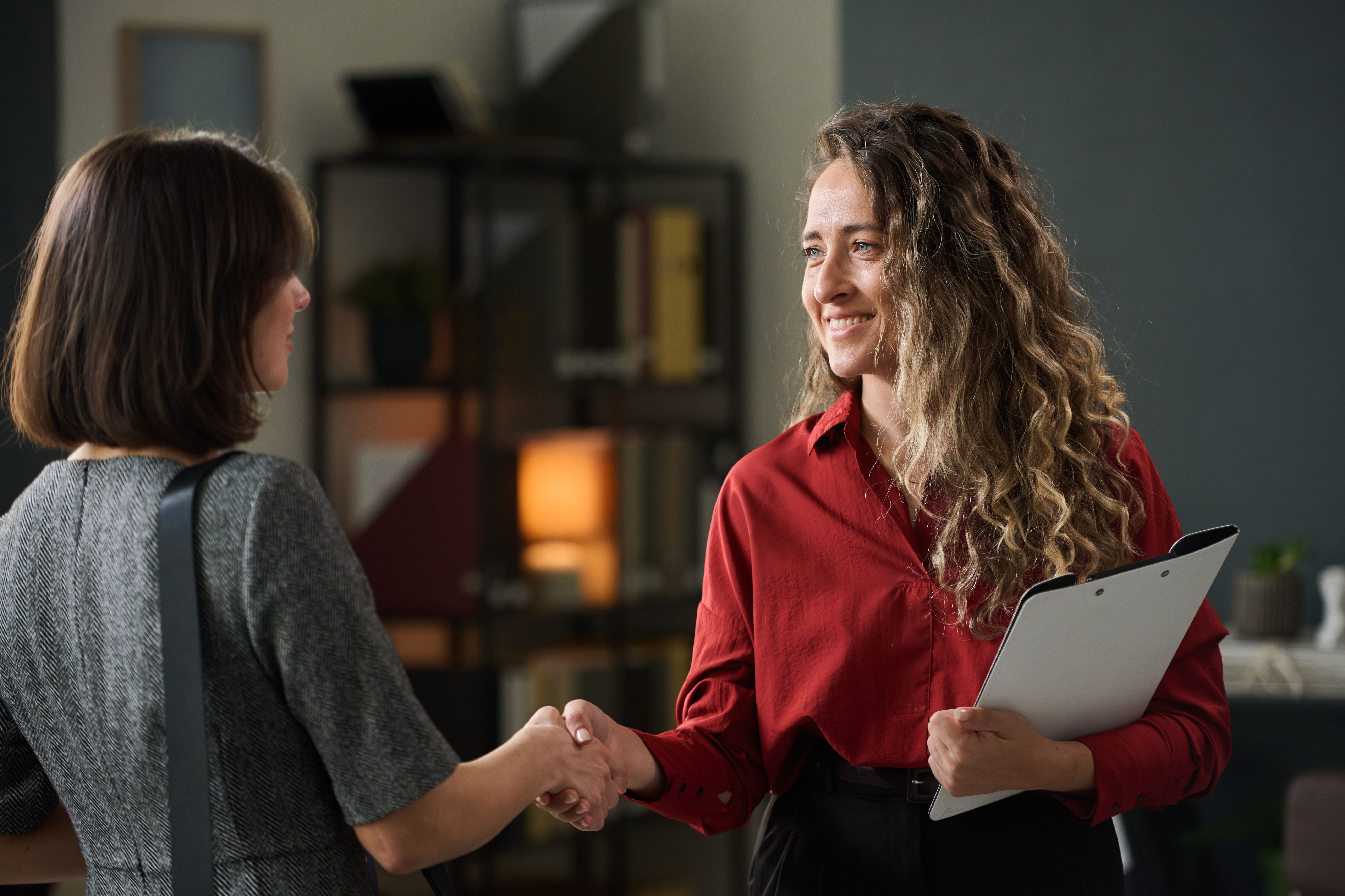 Greeting Business Colleague in Office Environment