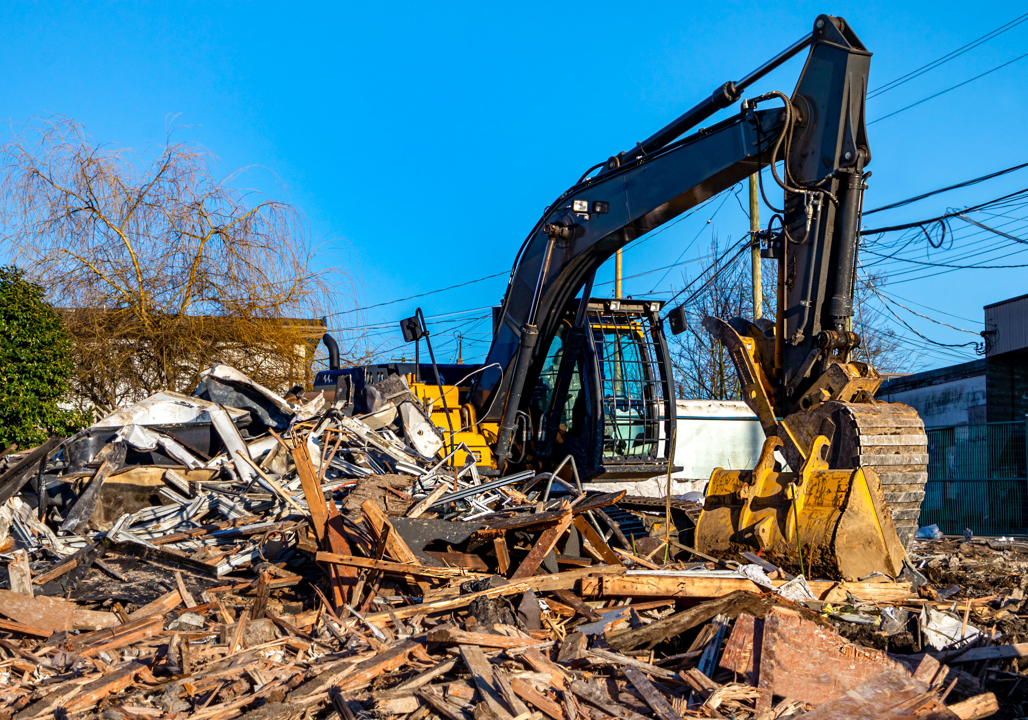 Demolition bulldozer in midst of building rubble.