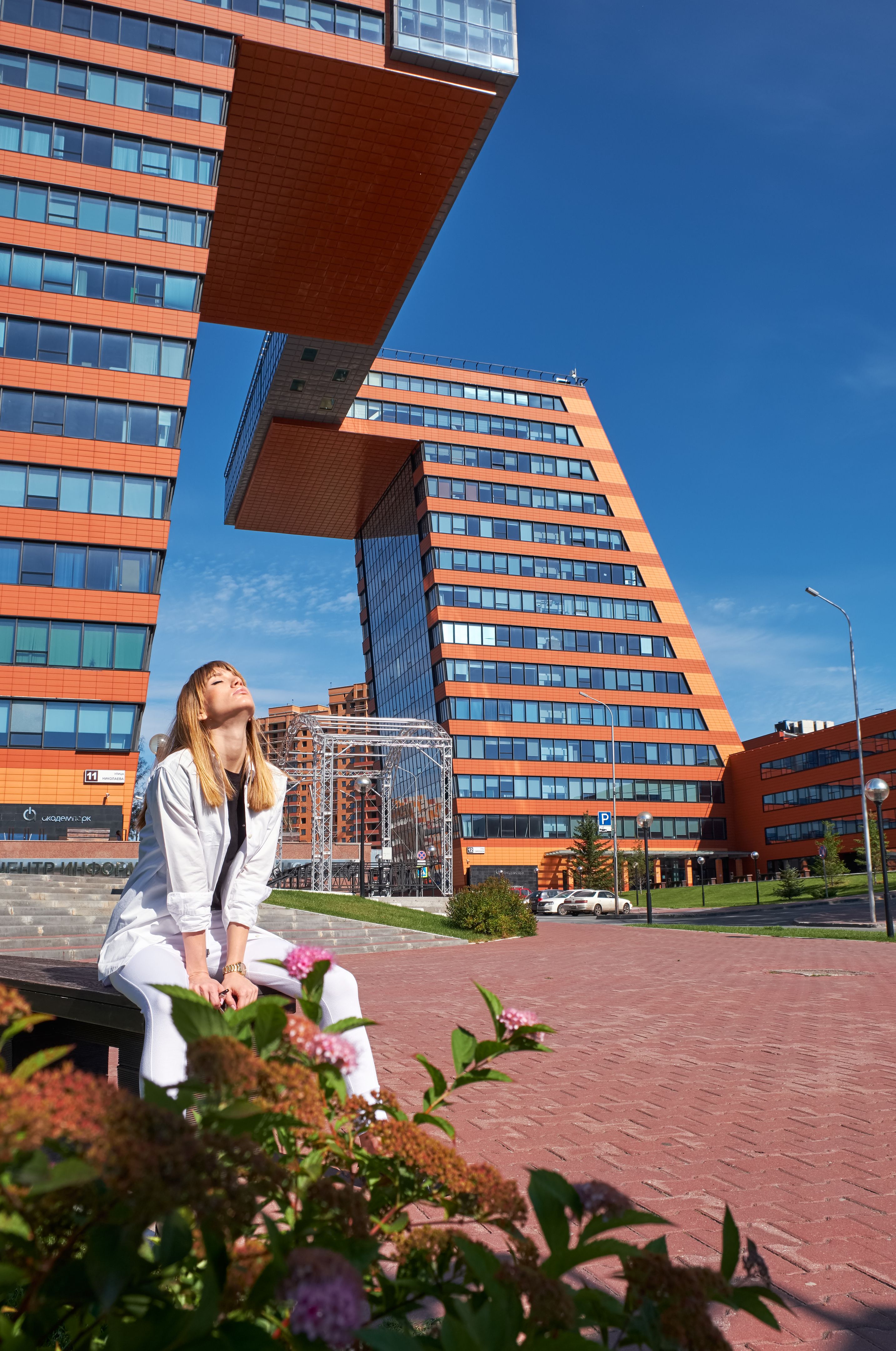 Modern young woman on the steps of Building of Information Technology Center in Akademgorodok. The symbol of Novosibirsk technopark Modern young woman on the steps of Building of Information Technology Center in Akademgorodok. The symbol of Novosibirsk technopark