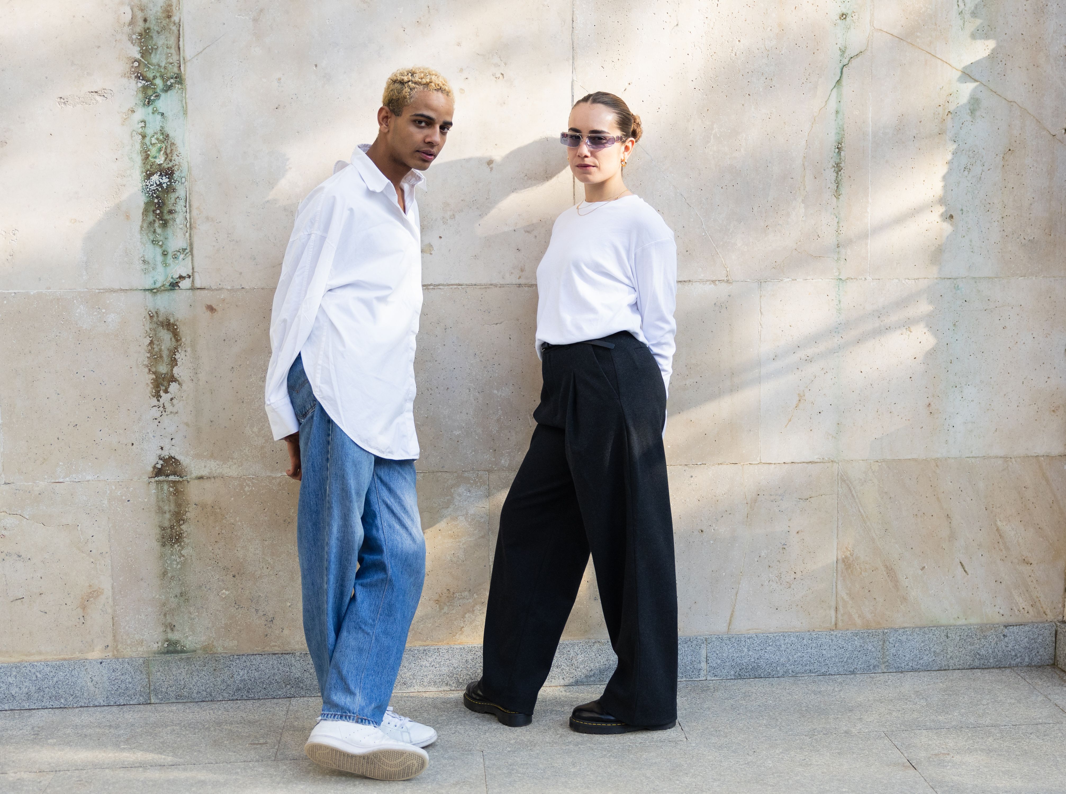 Fashionable Young Duo in Monochrome Outfits, copy space.