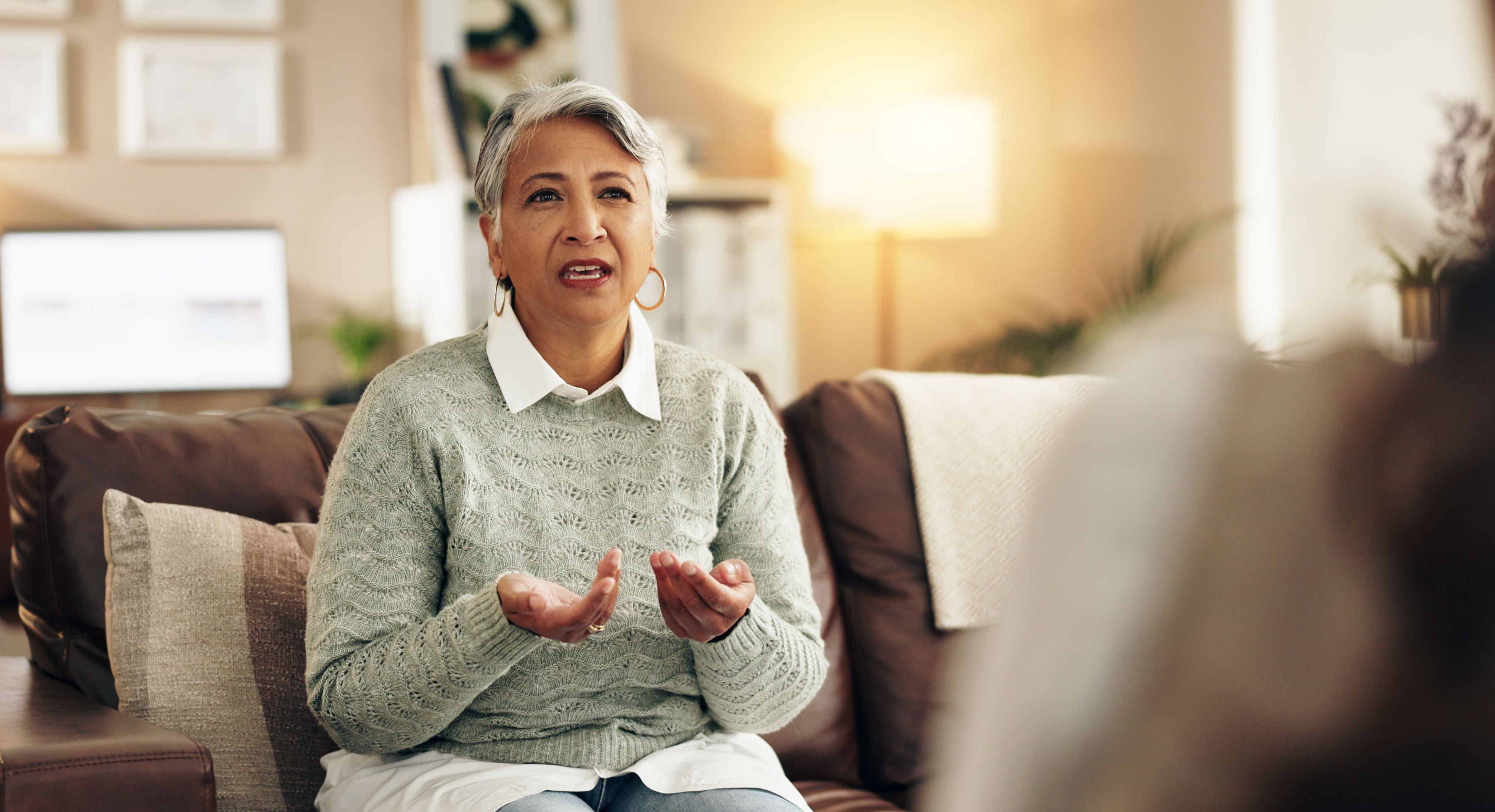 Conversation, therapist and patient in office for mental health, stress or anxiety at appointment. Discussion, medical and mature woman talking to psychologist for advice in consultation at clinic.