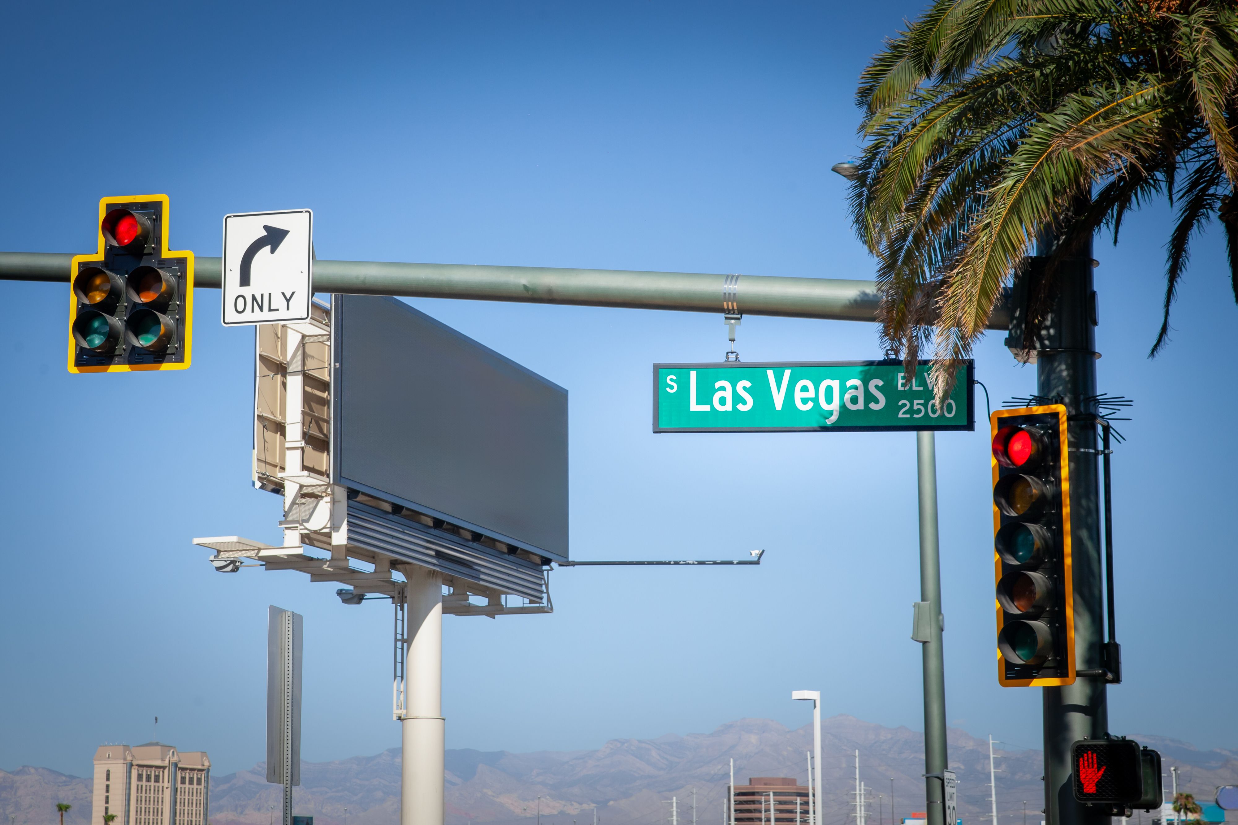 A typical American intersection on Las Vegas Boulevard (or las vegas strip), featuring traffic lights, road signs, and palm trees, symbolizing the urban landscape of Las Vegas, Nevada. A typical American intersection on Las Vegas Boulevard (or las vegas strip), featuring traffic lights, road signs, and palm trees, symbolizing the urban landscape of Las Vegas, Nevada.