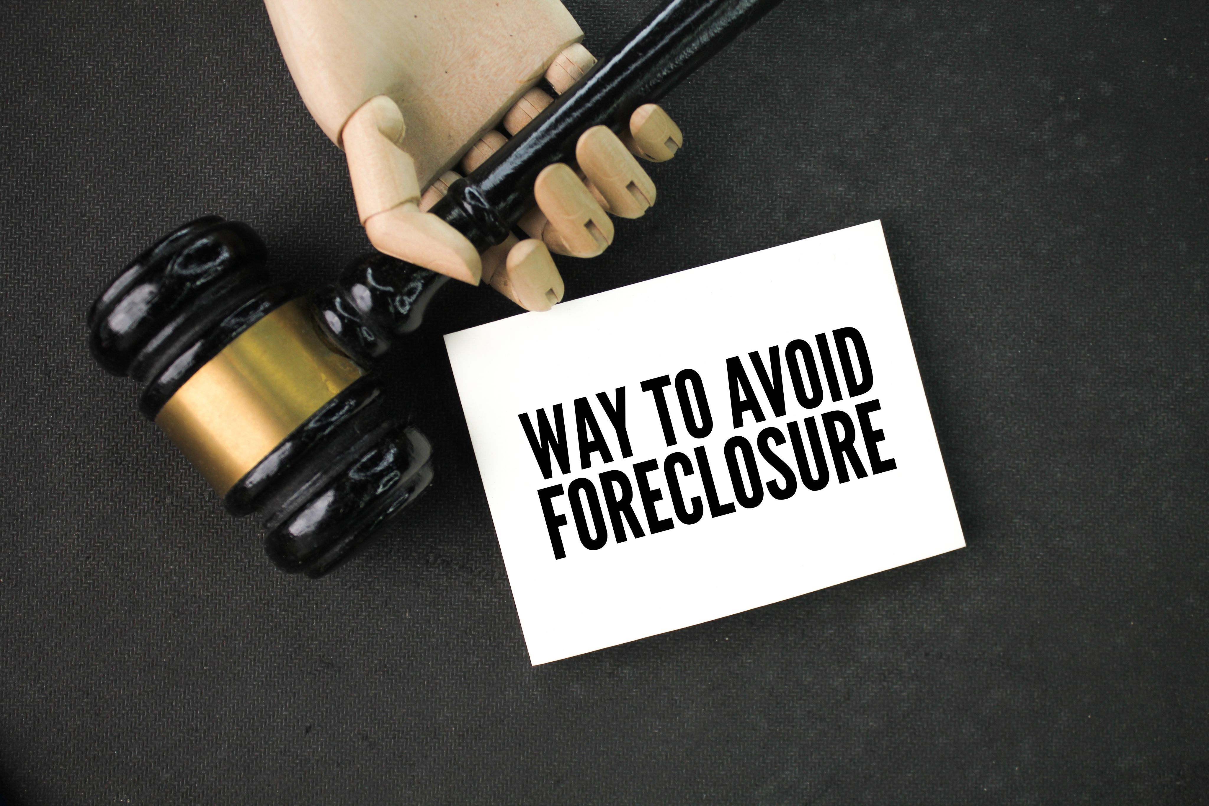 a judge's gavel and a notebook with the words Ways to Avoid Foreclosure. concept of seizure a judge's gavel and a notebook with the words Ways to Avoid Foreclosure. concept of seizure