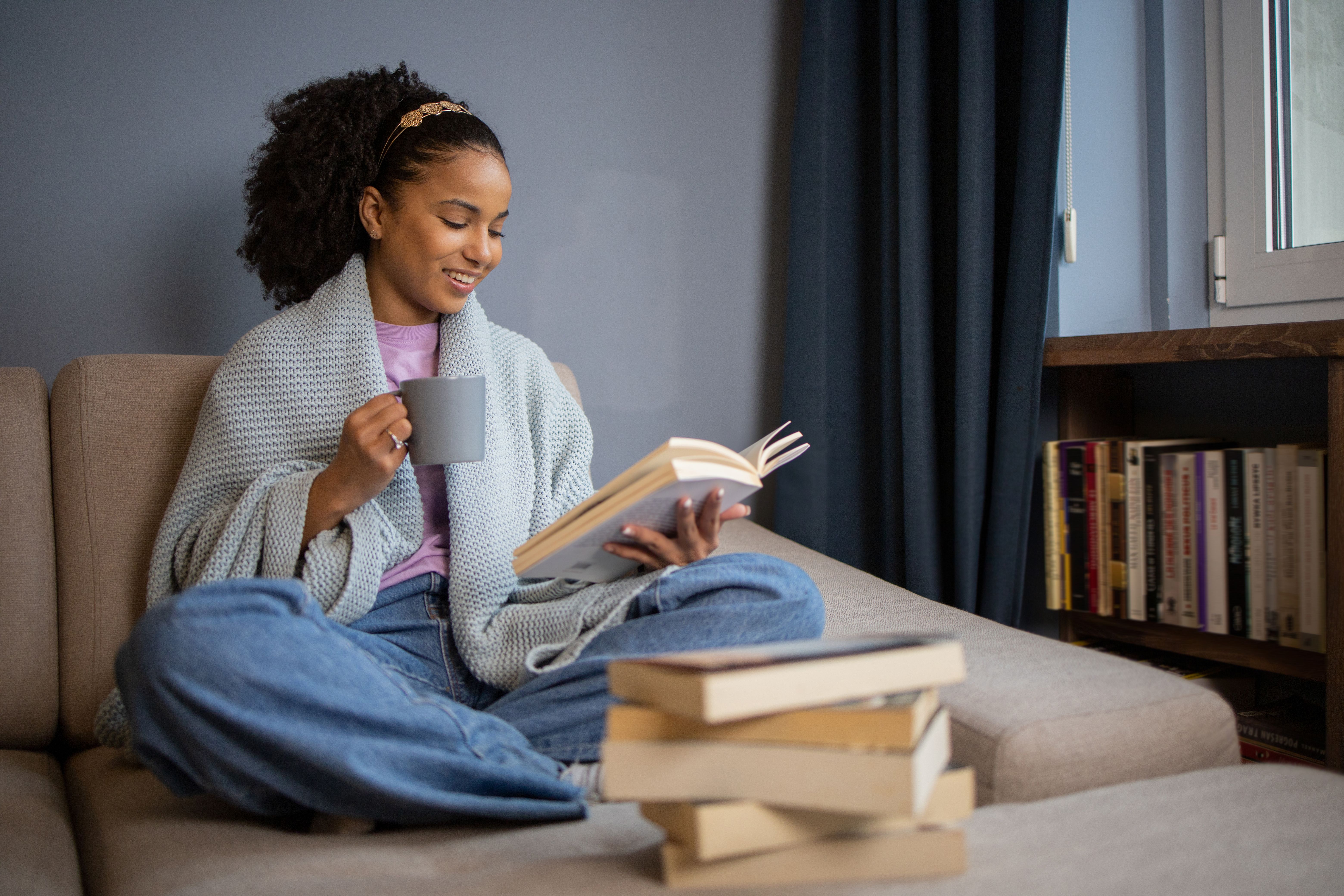 Happy woman reading book at home