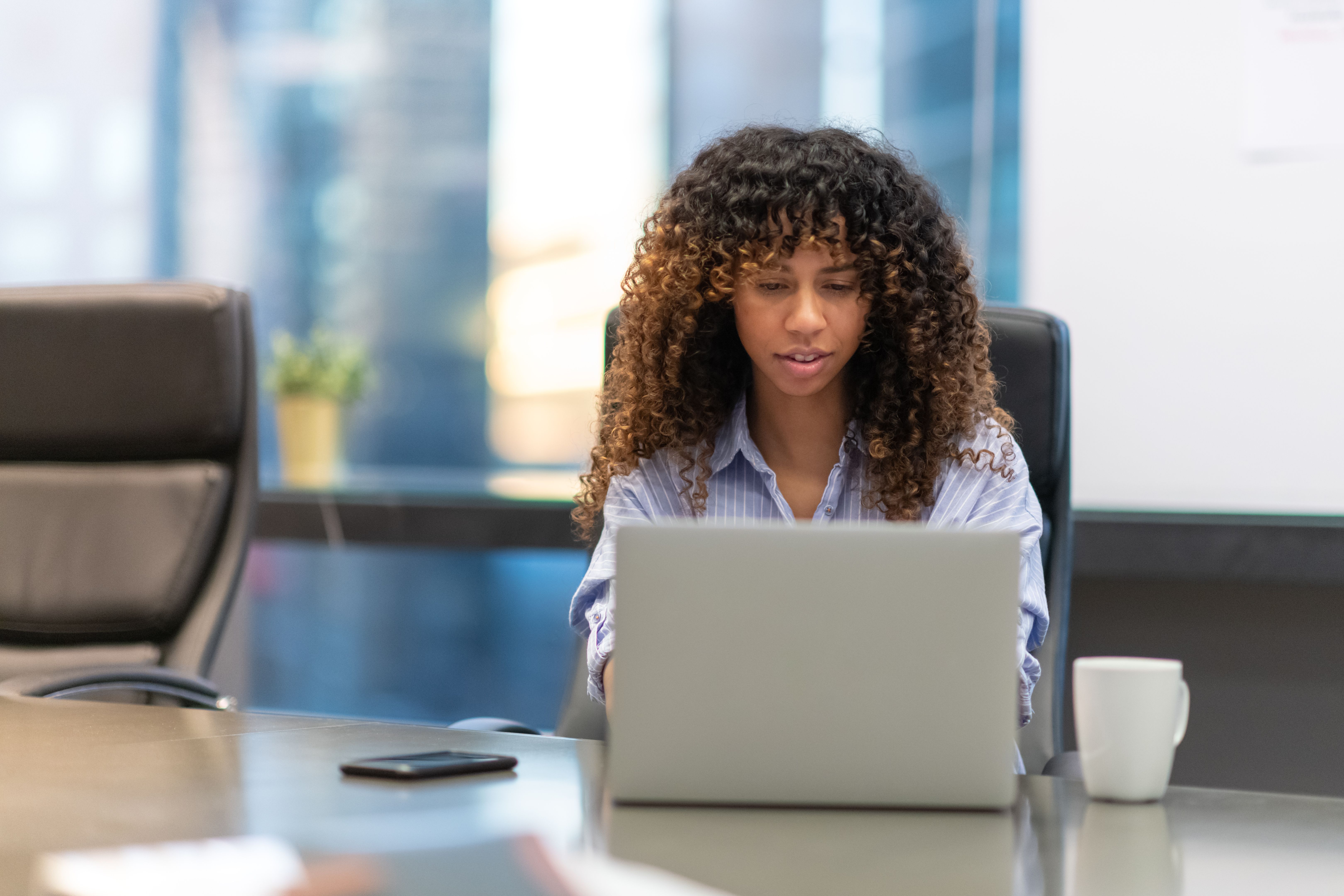 Woman concentrates while working on her laptop