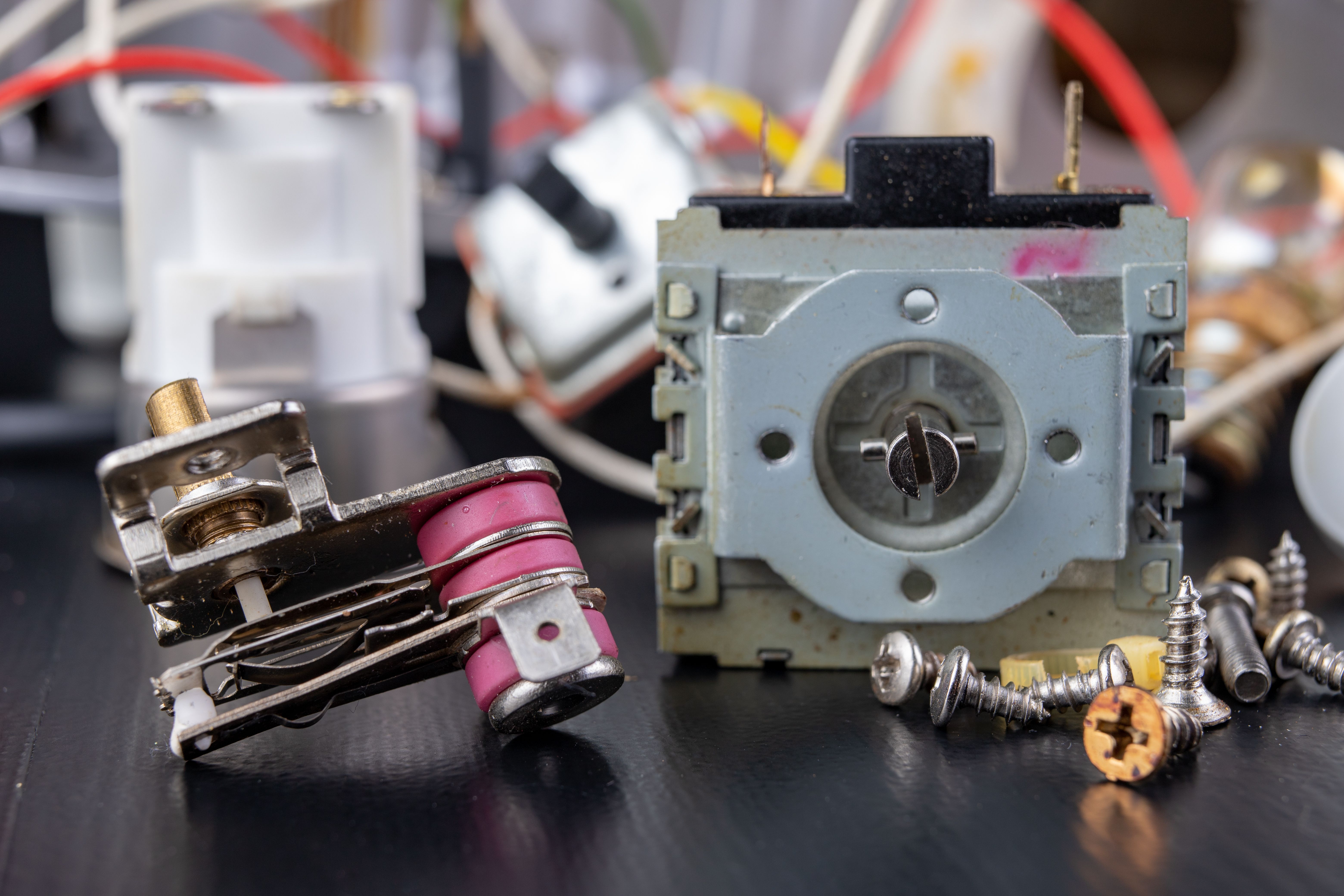Spare parts for the repair of a household oven. A split stove for baking dishes. Black background. Spare parts for the repair of a household oven. A split stove for baking dishes. Black background.
