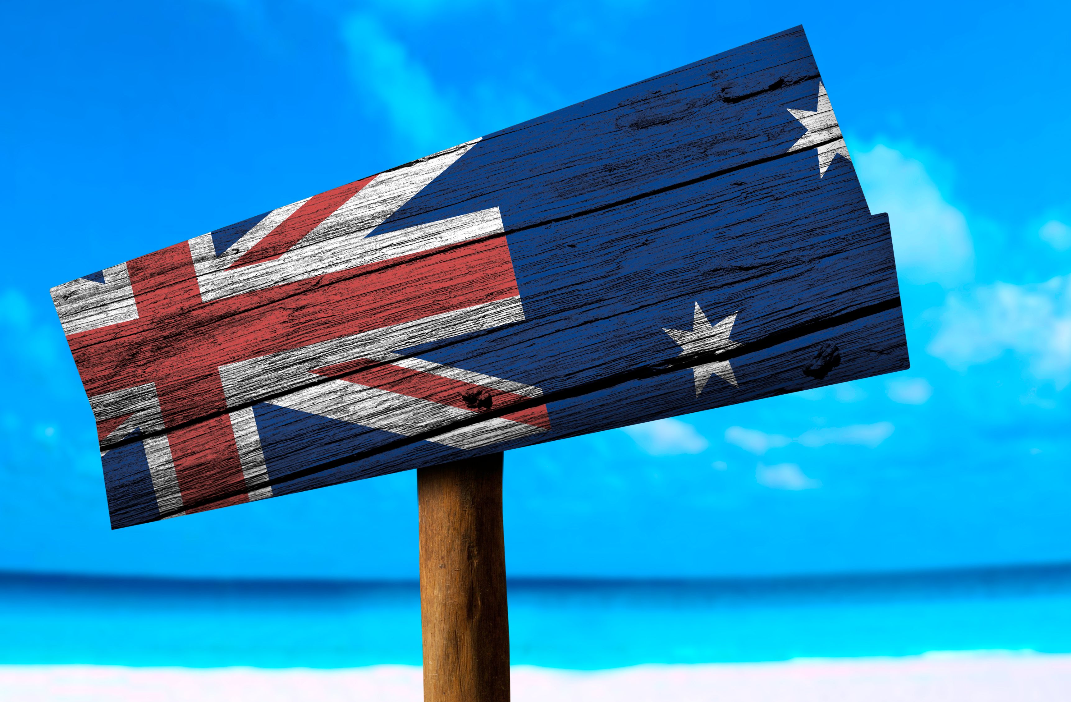 Australia flag wooden sign with a beach on background