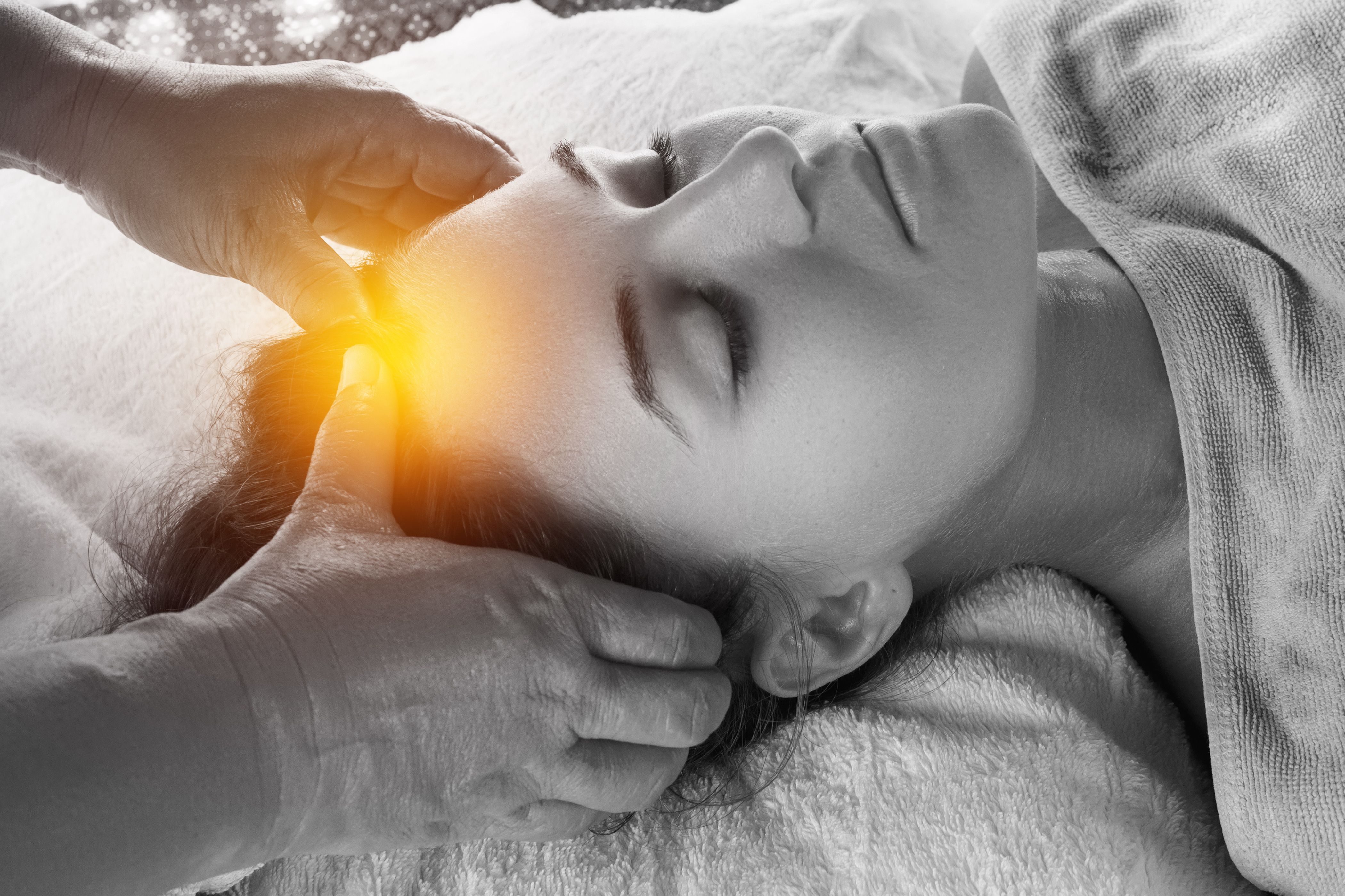Woman during healing head massage therapy in Asian traditional clinic Woman during healing head massage therapy in Asian traditional clinic