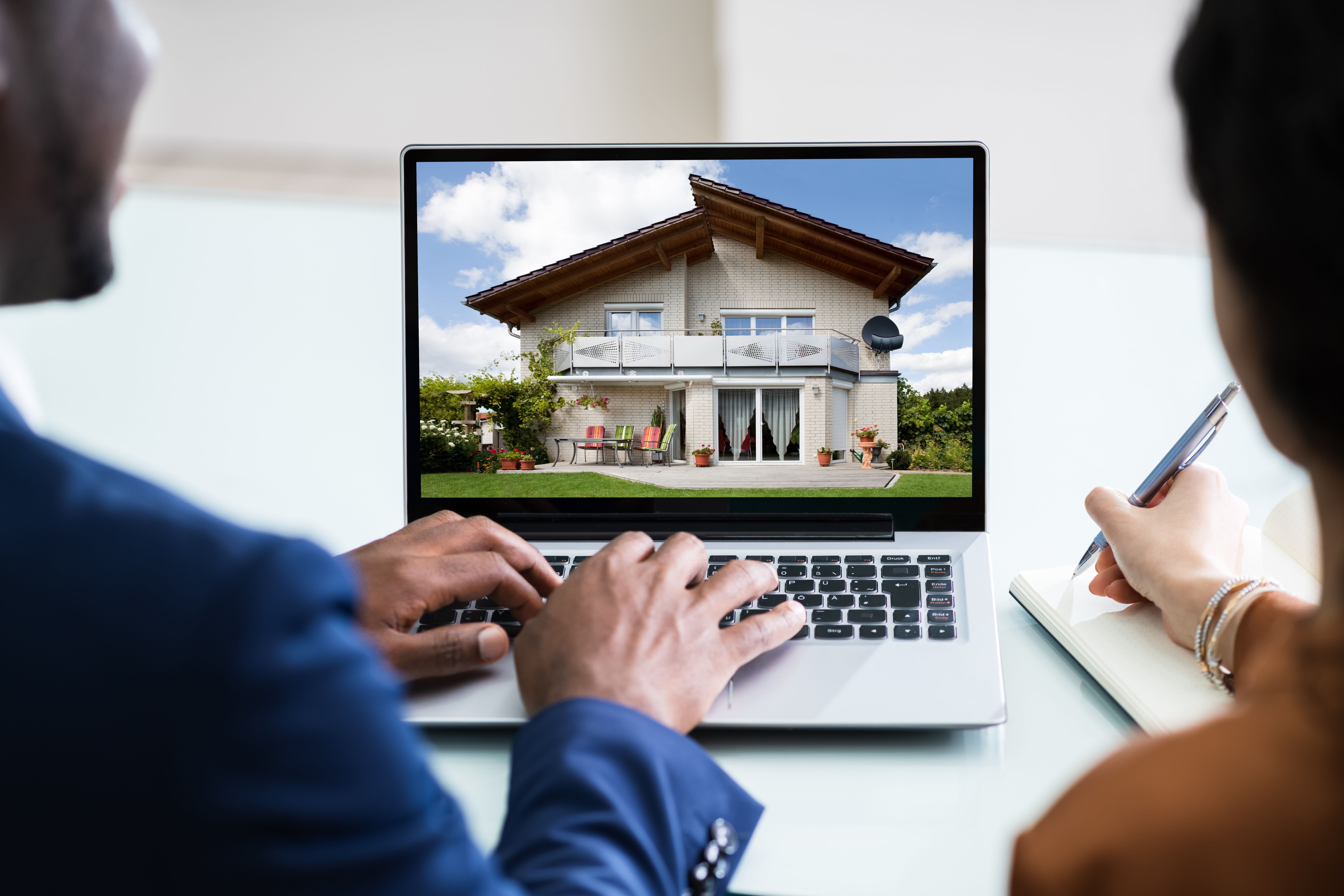 Couple Looking At House On Laptop Couple Looking At House On Laptop