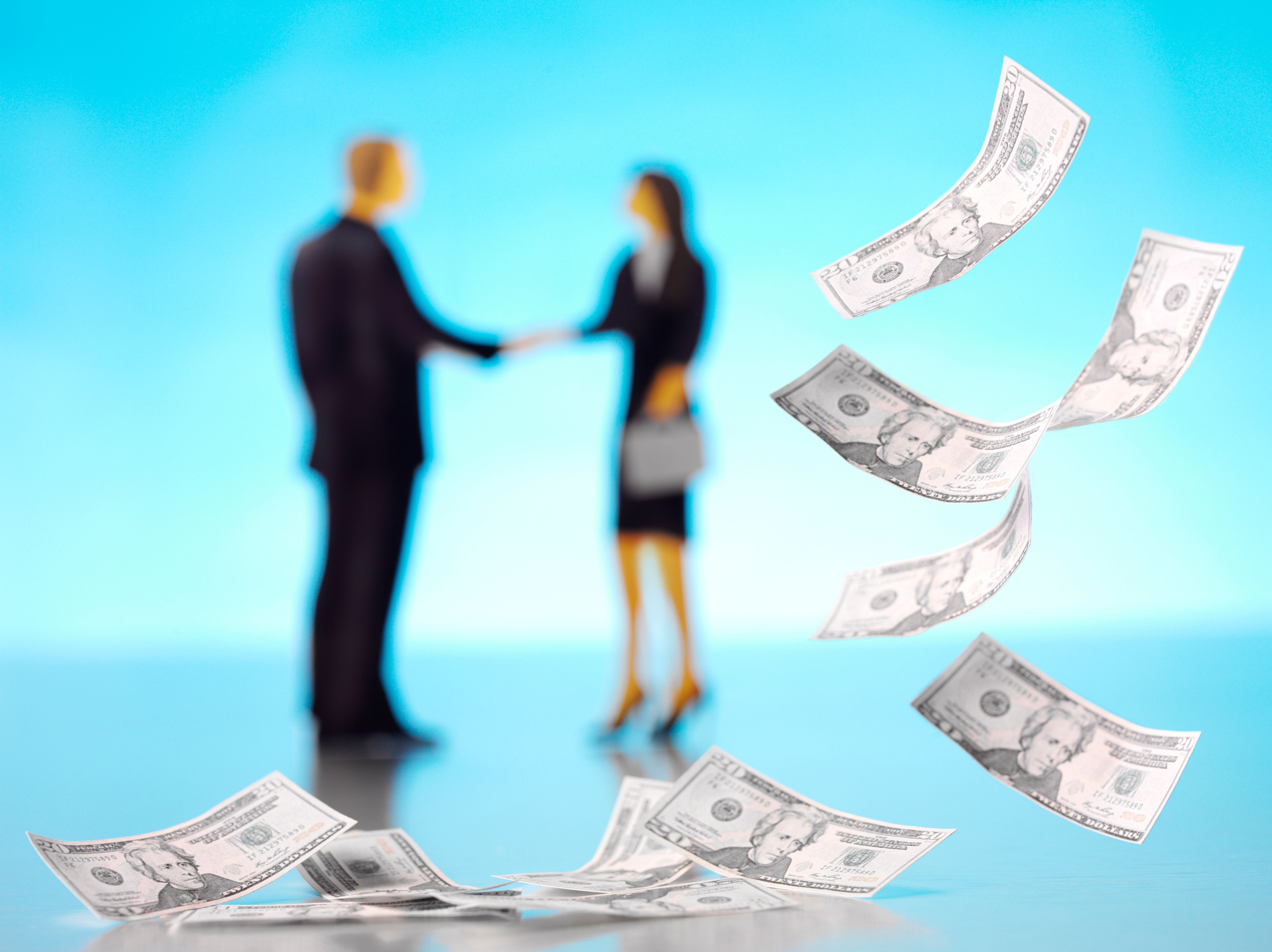 Businessman and Woman with 100 Dollar American Bills