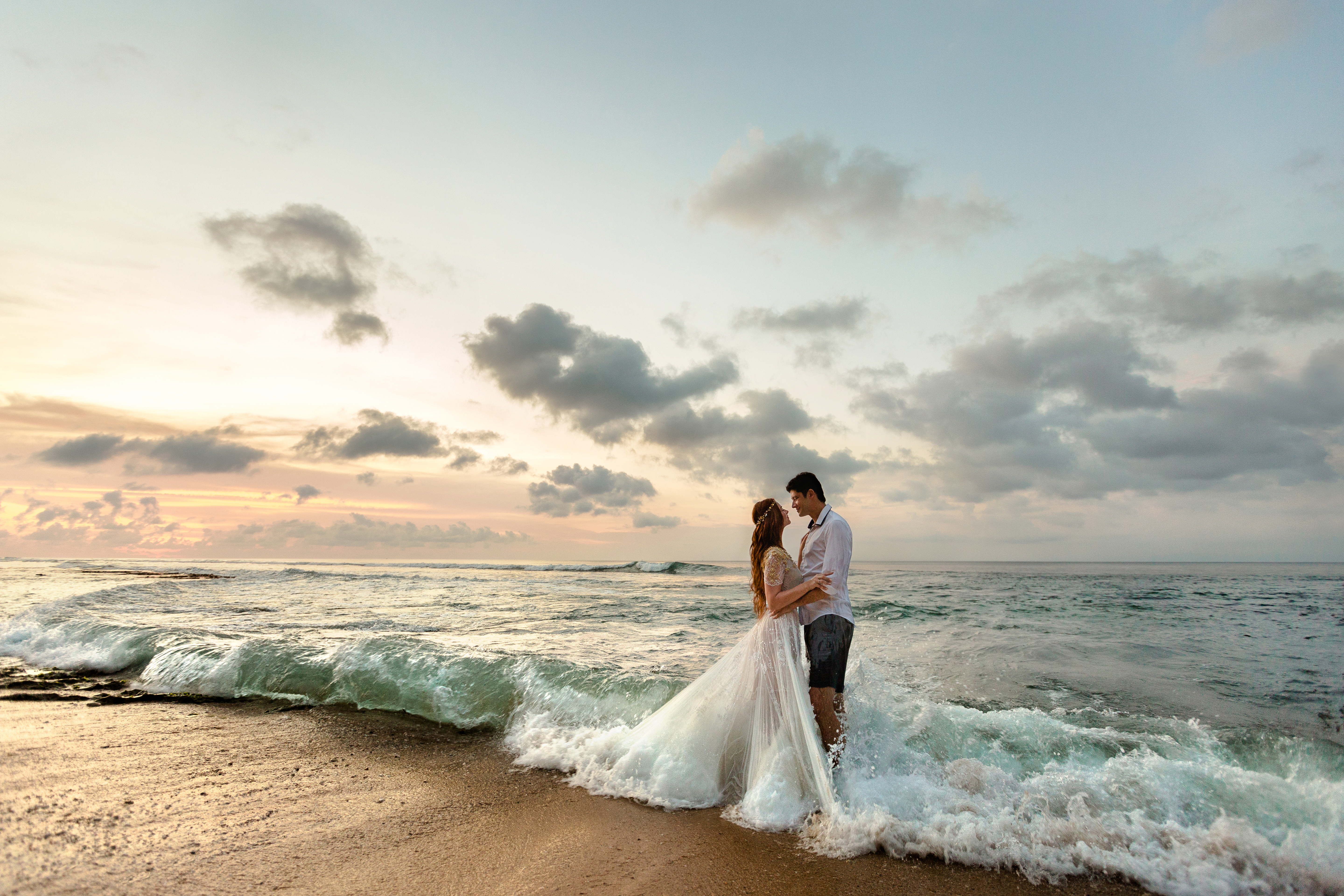 Newlyweds on the beach at sunset