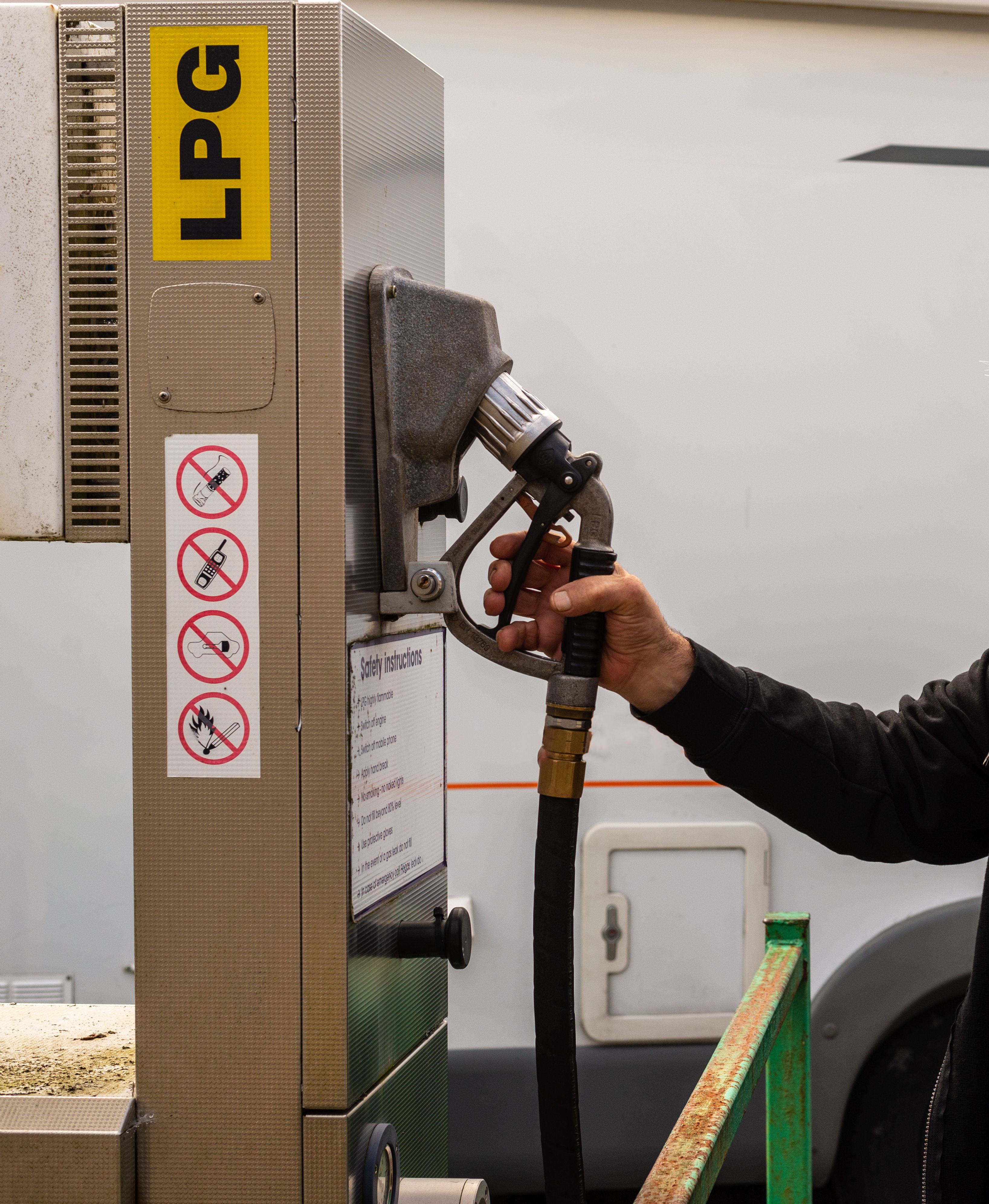 senior man preparing to fill up the LPG tanks in his motor home