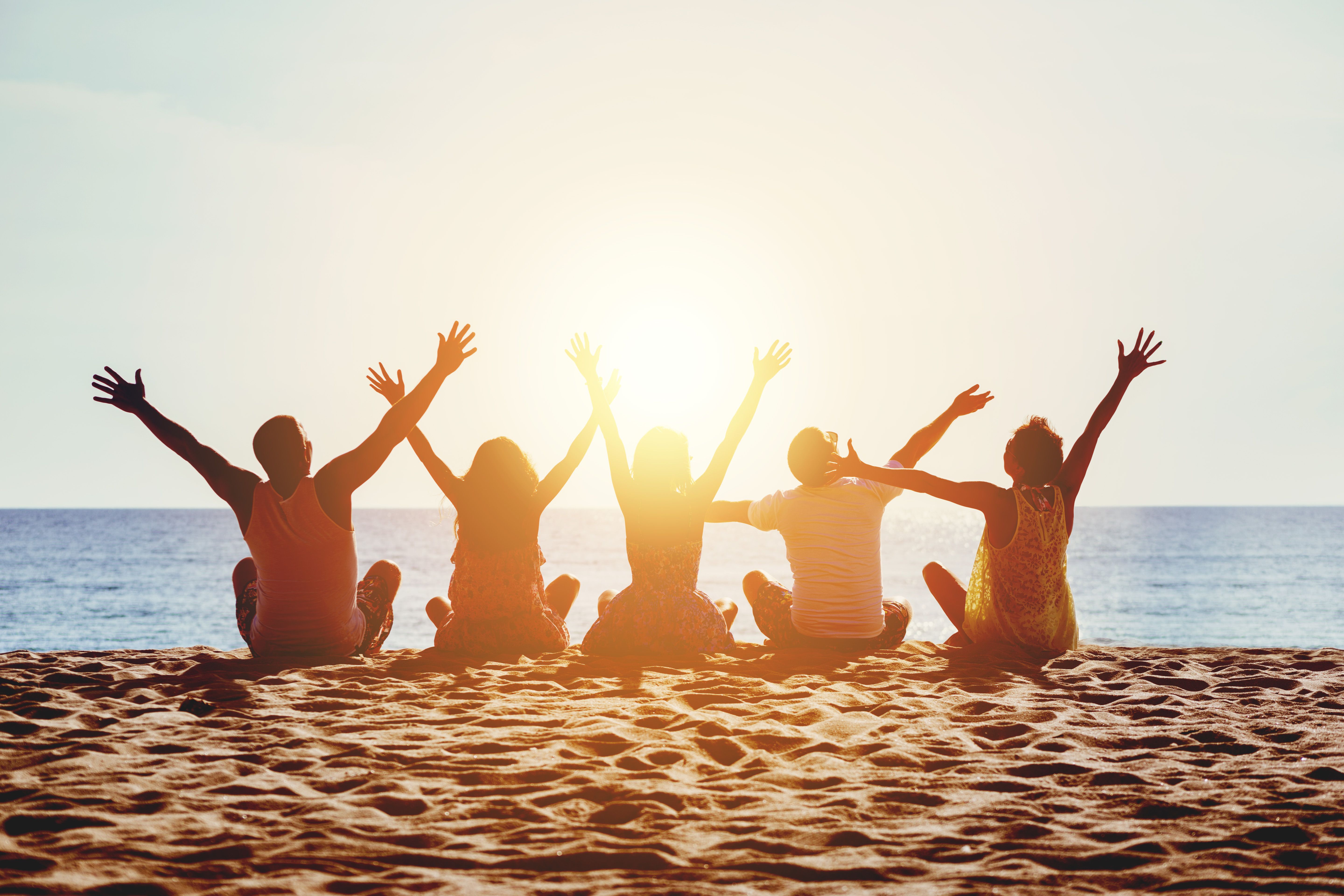 Group happy people beach sea sunset concept