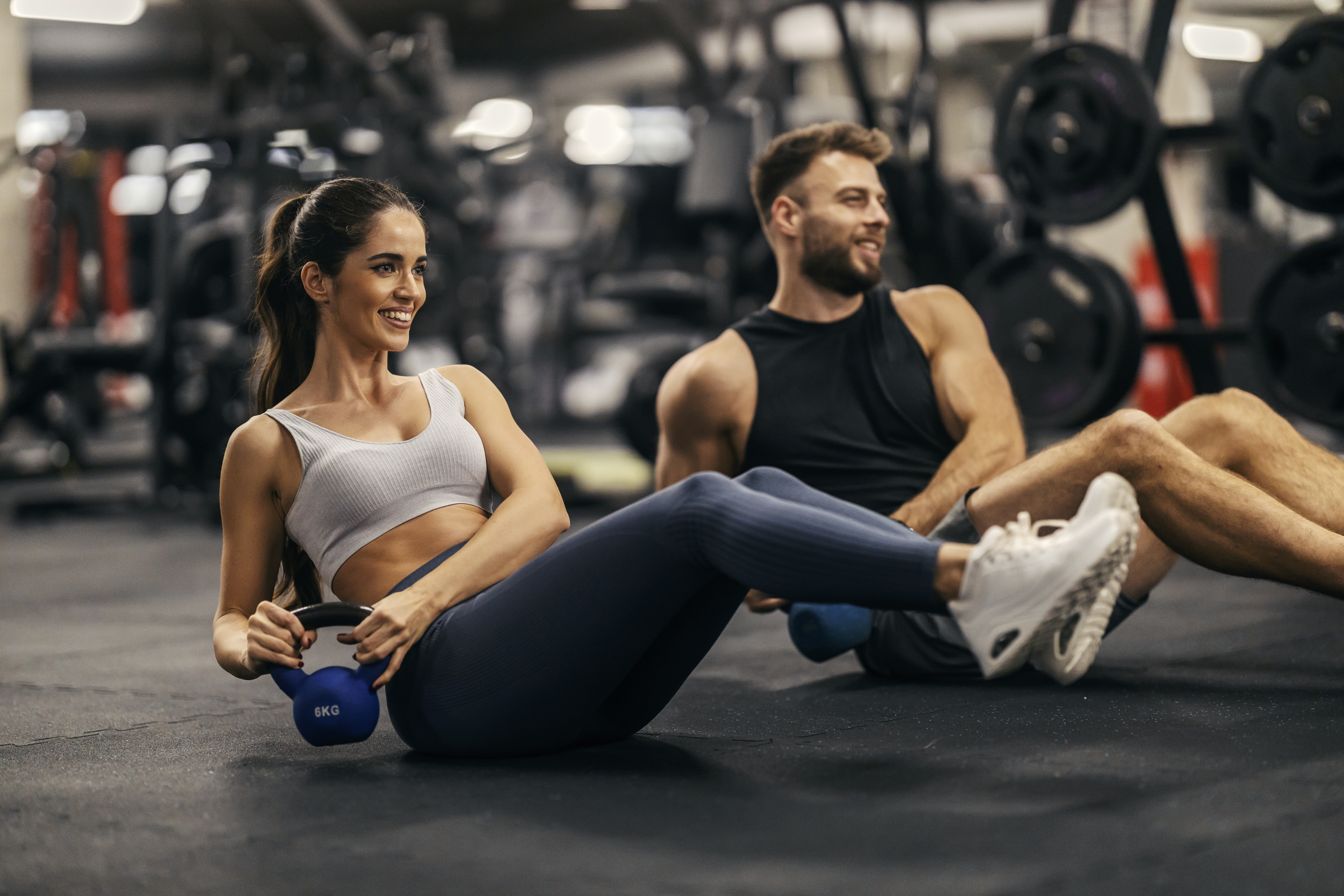 Fitness couple is doing kettlebell twist in a gym togehter. Fitness couple is doing kettlebell twist in a gym togehter.