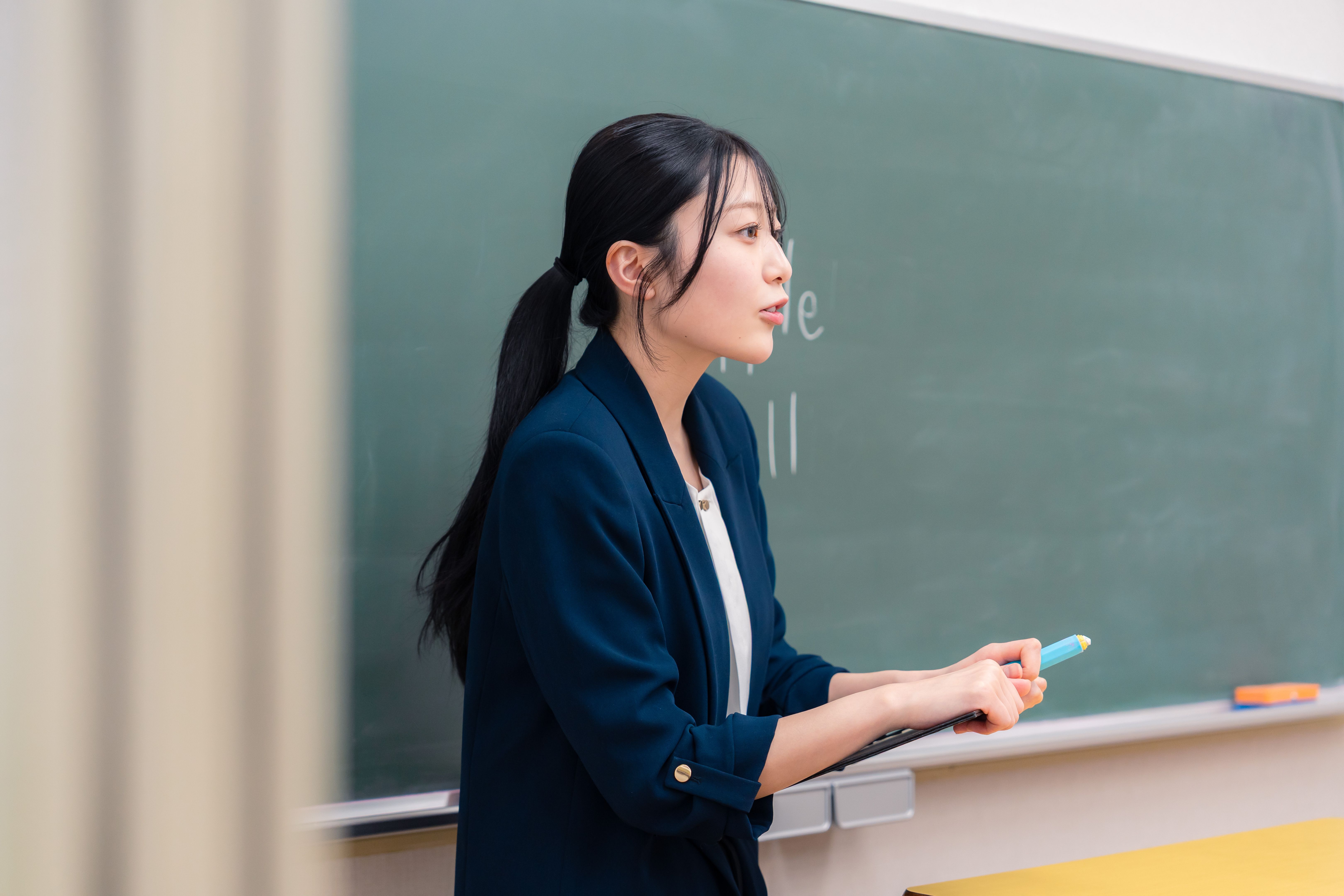 Female teacher teaching English at school