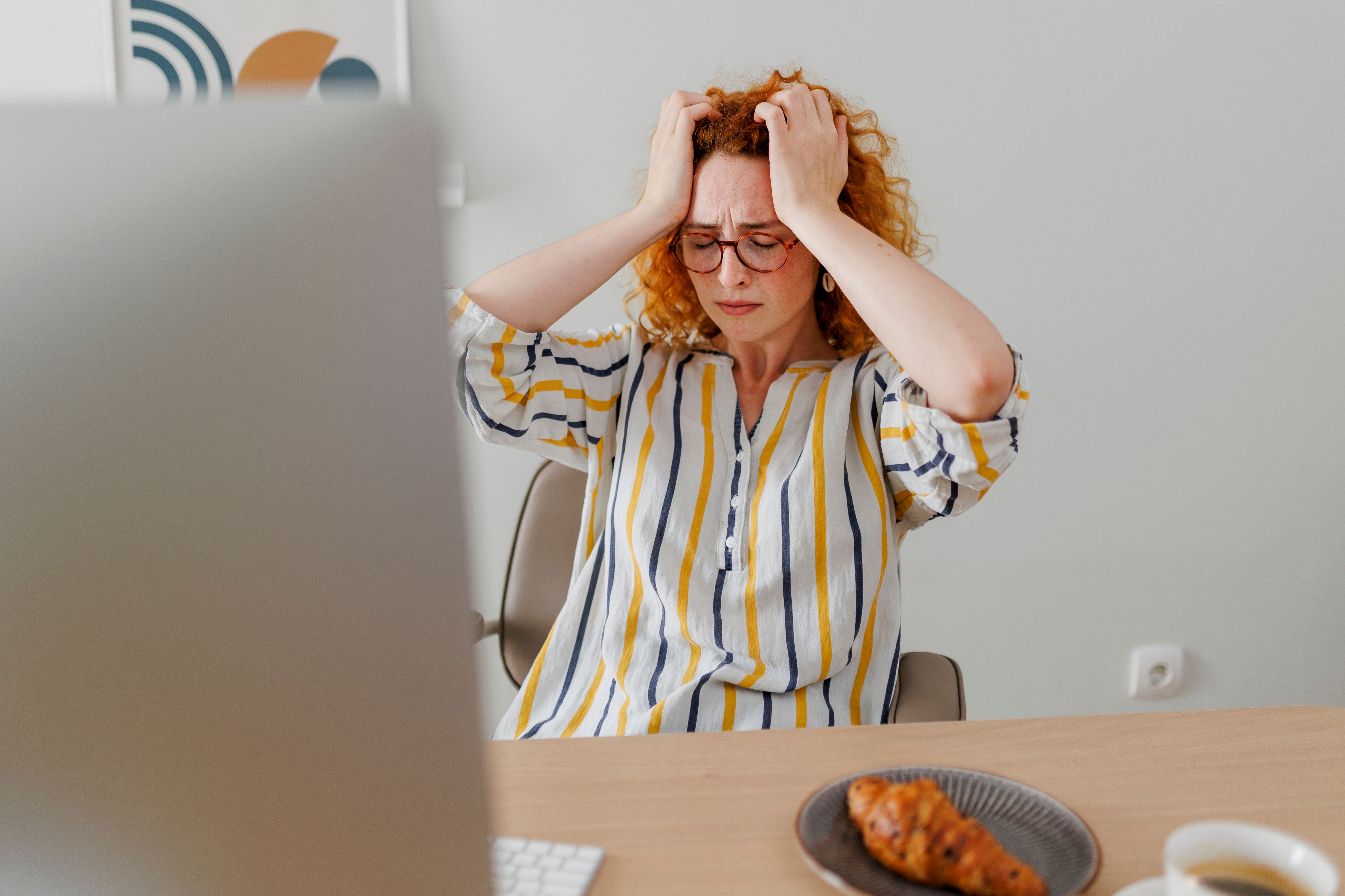Shot of a young businesswoman looking stressed out while working in an office