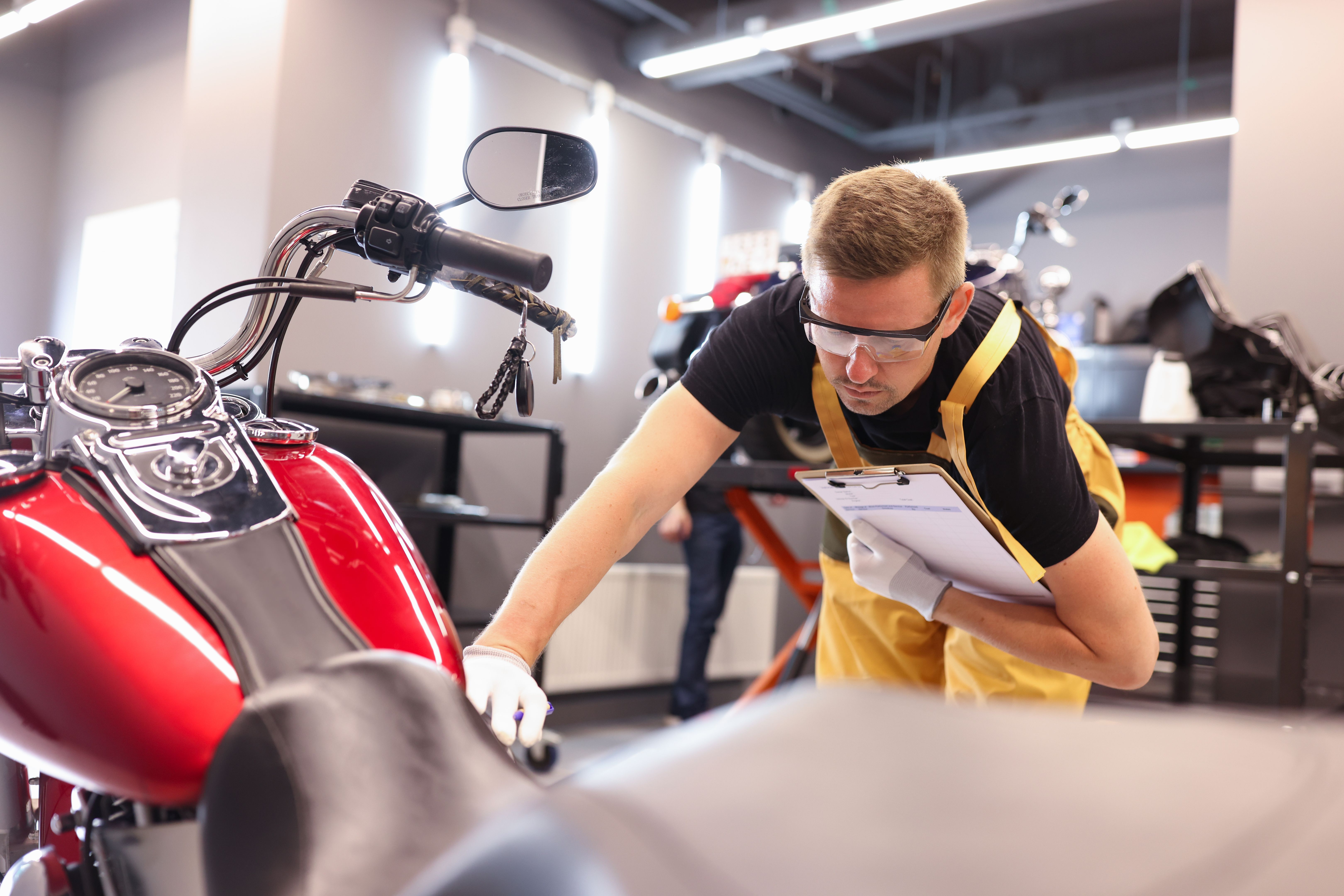 mechanic inspecting motorcycle