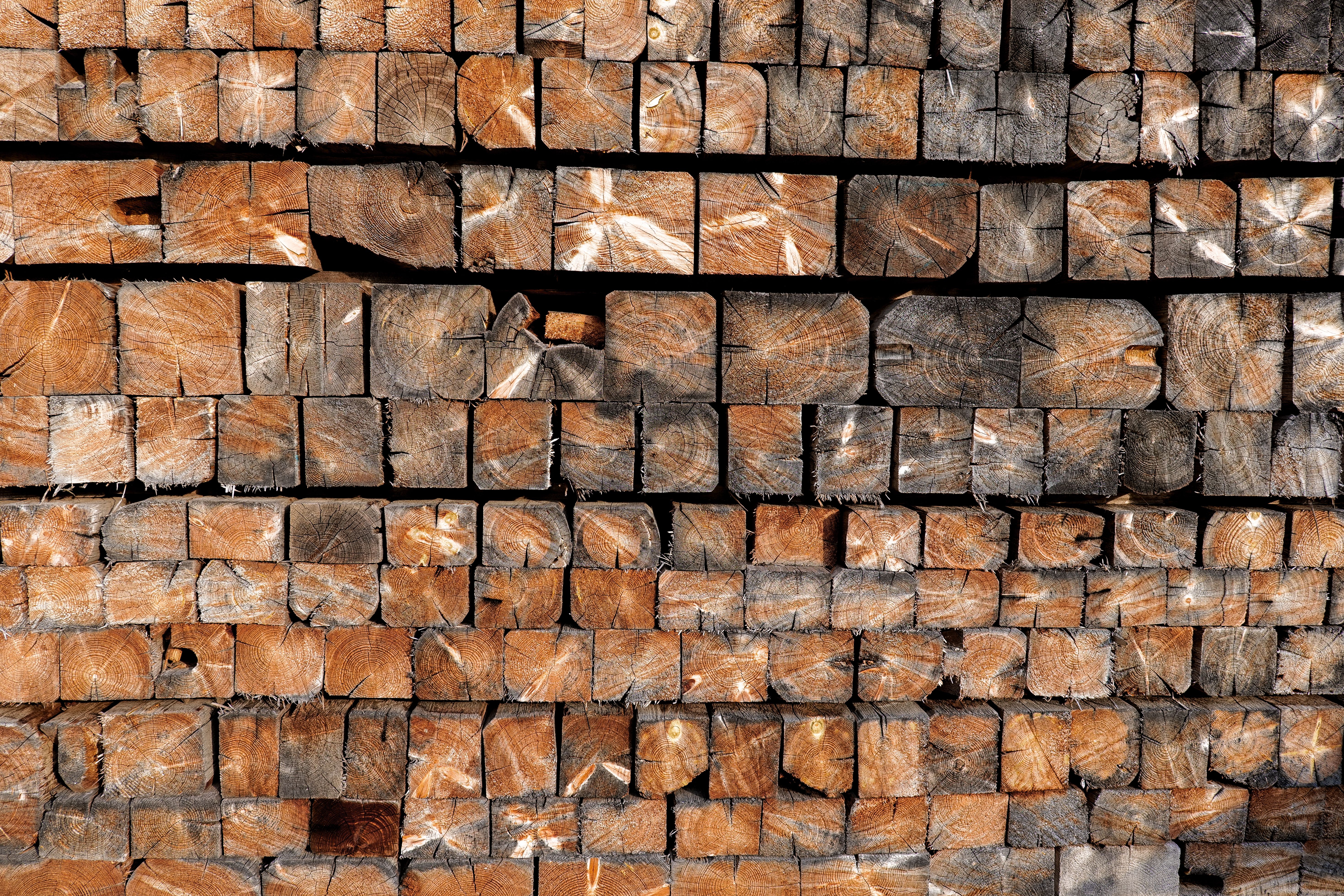 Stacked Wooden Beams with Natural Texture. Rustic vintage background. Square wooden bars wallpaper.