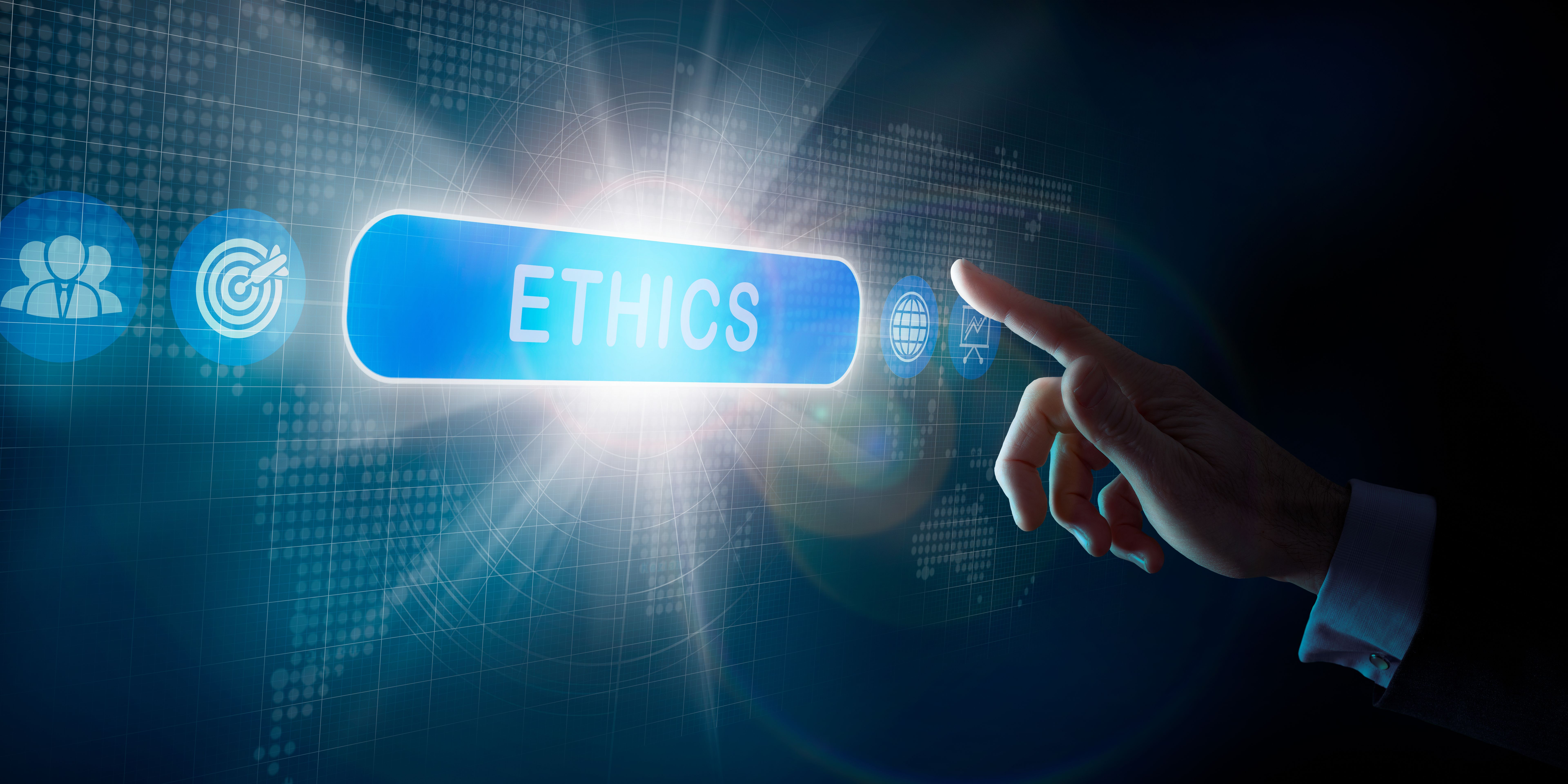 A businessmans hand selecting an Ethics business word concept on a computer display.