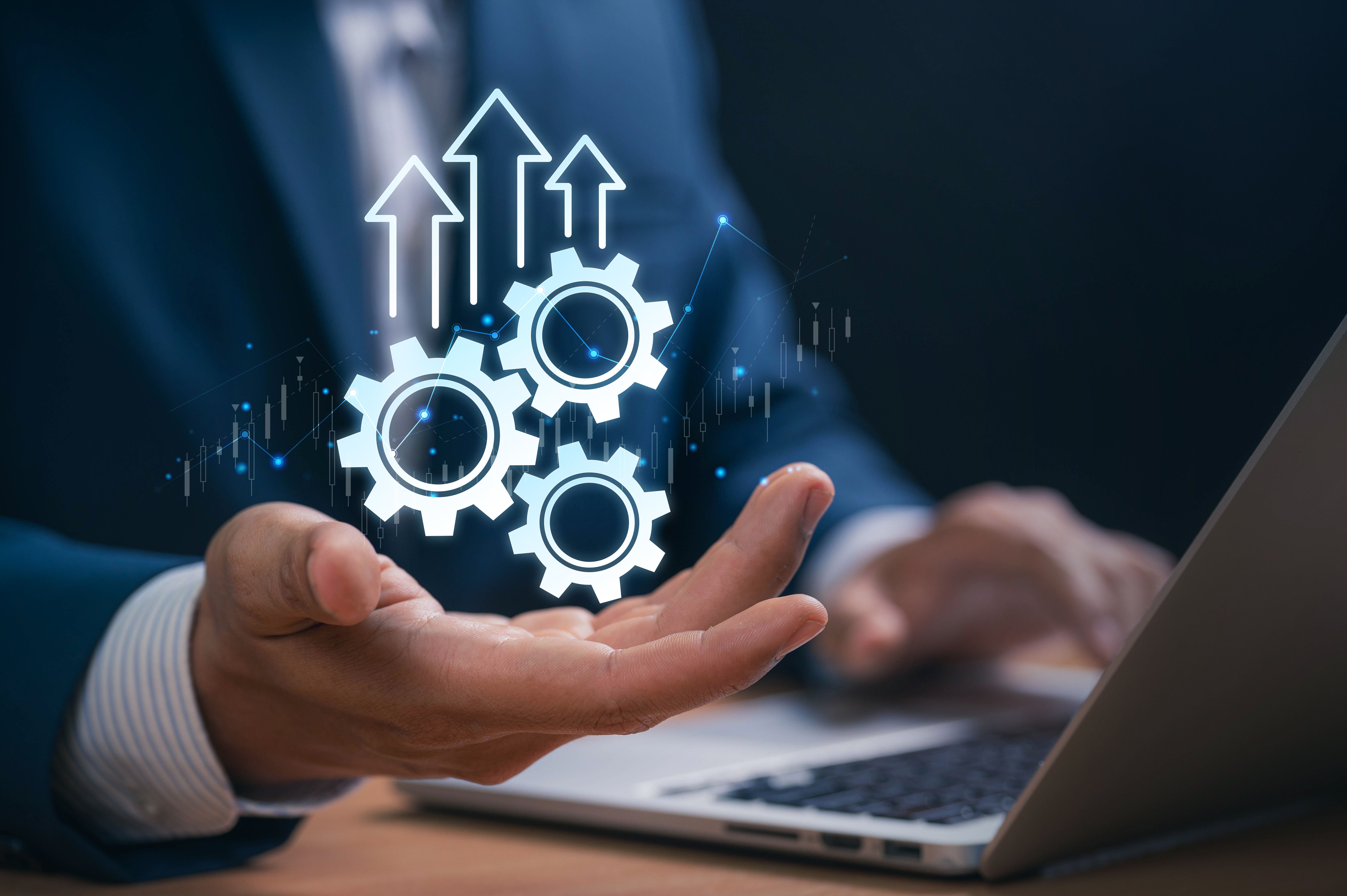 Productivity and Automation Strategy for Business Success. Businessman hand showing digital gears and arrows. system optimization, growth performance, and innovation in digital transformation