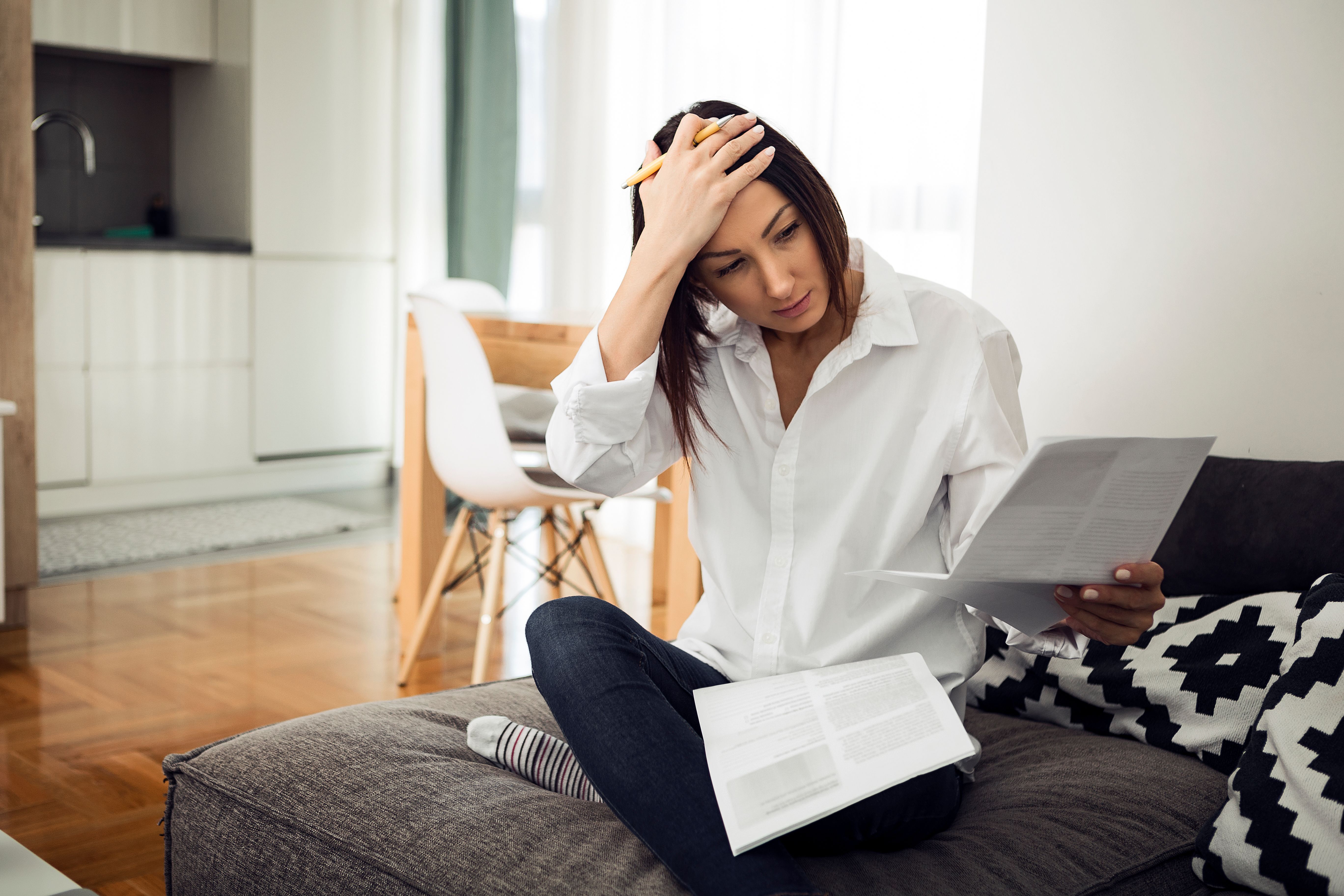 Young woman with documents in living room
