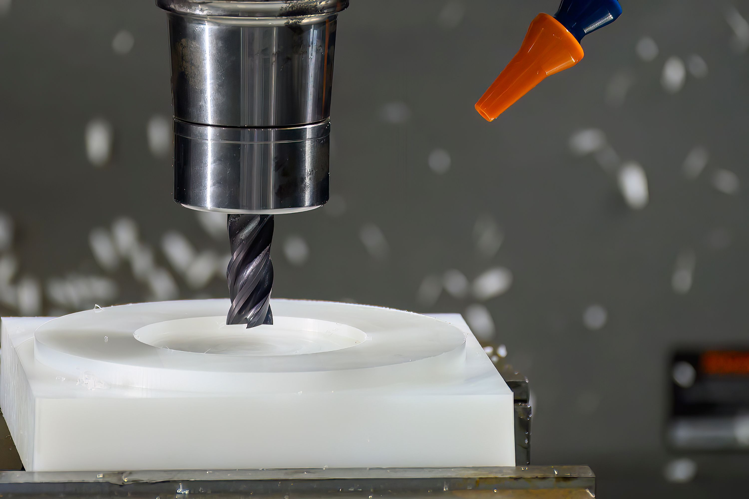 The CNC milling machine cutting the nylon 6 material part with flat end mill tool. The CNC milling machine cutting the nylon 6 material part with flat end mill tool.