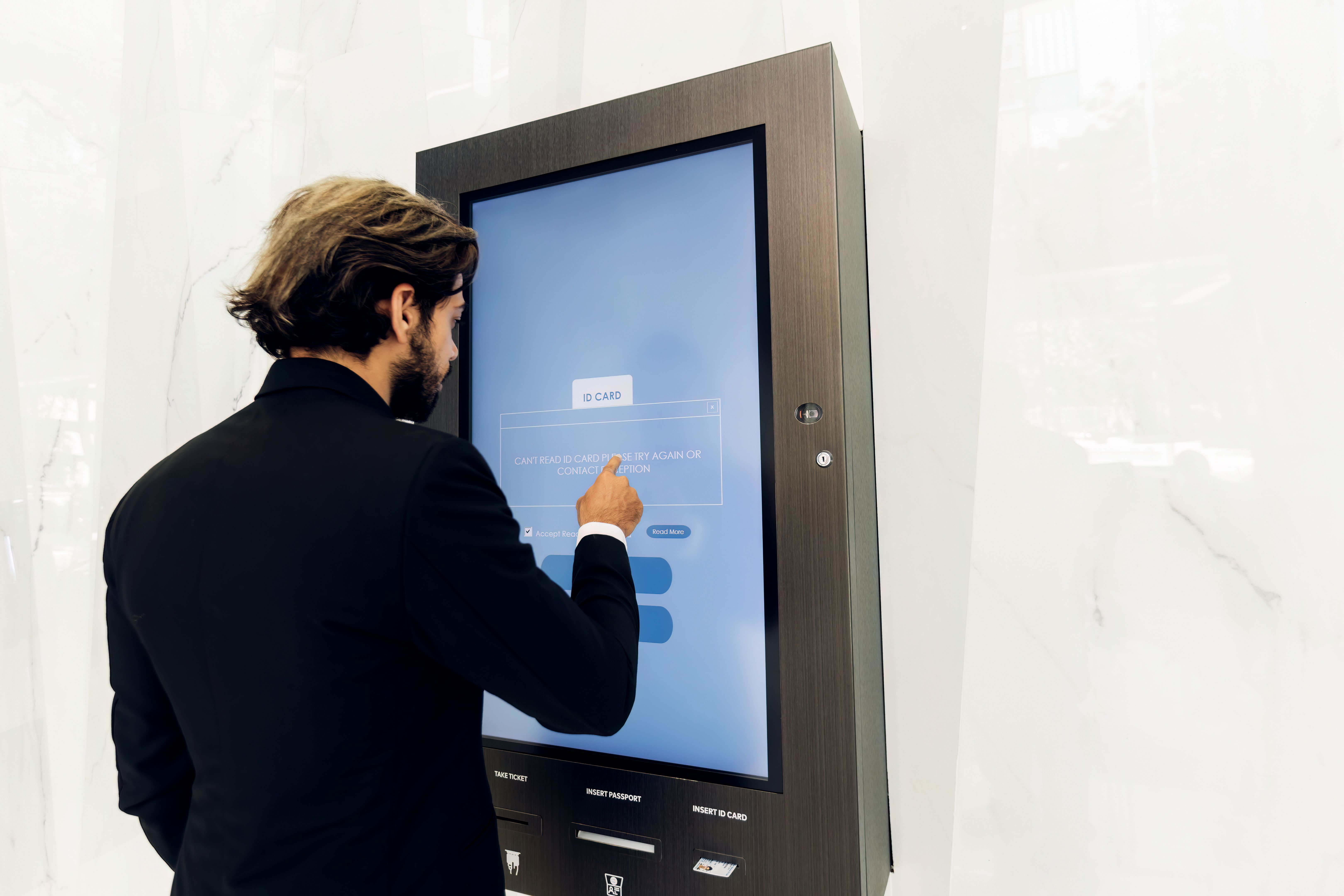 Businessman using card to open automatic gate machine in office building. Male using smart card to open automatic gate machine in office building. Working routine concept.