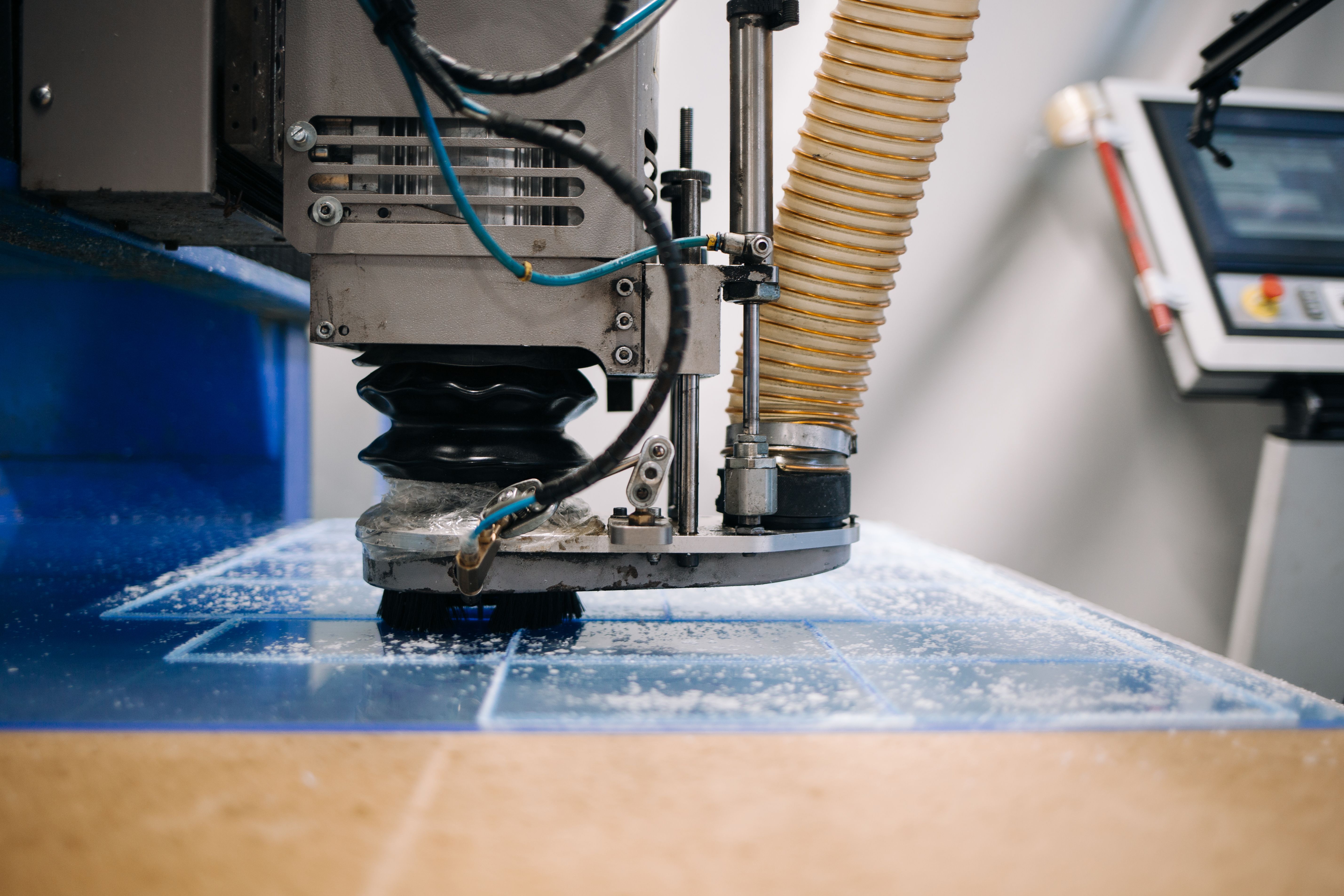 Milling cutter cuts plastic part on robotized production line