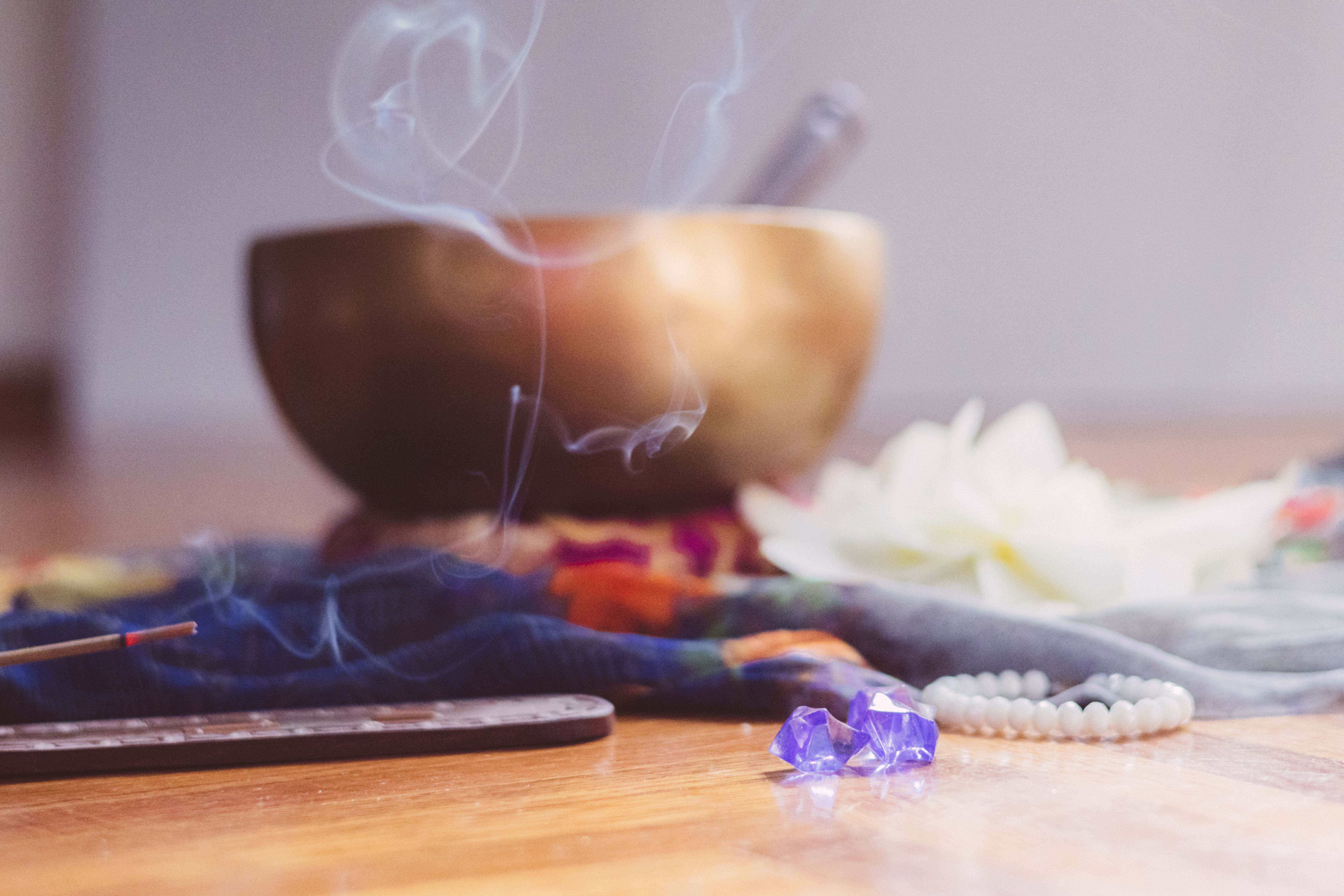 Healing Tibetan singing bowl, Indian incense stick in stick holder burning with smoke and lotus flower on the beautiful saree. Meditation, destress, relaxation, mental health, spiritual practices. Energetical power concept Healing Tibetan singing bowl, Indian incense stick in stick holder burning with smoke and lotus flower on the beautiful saree. Meditation, destress, relaxation, mental health, spiritual practices. Energetical power concept