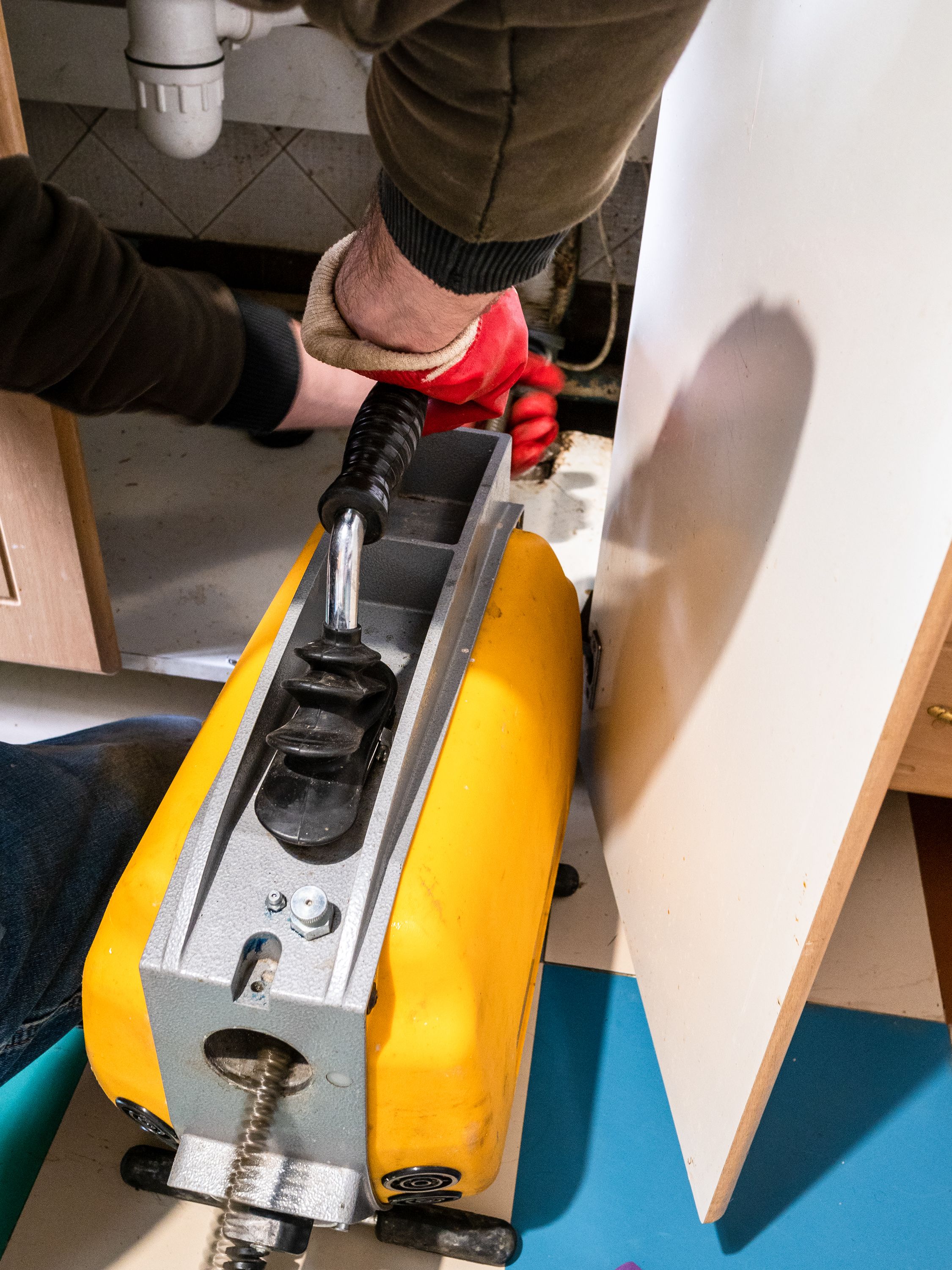 plumber cleaning sewer pipe drain cleaning machine